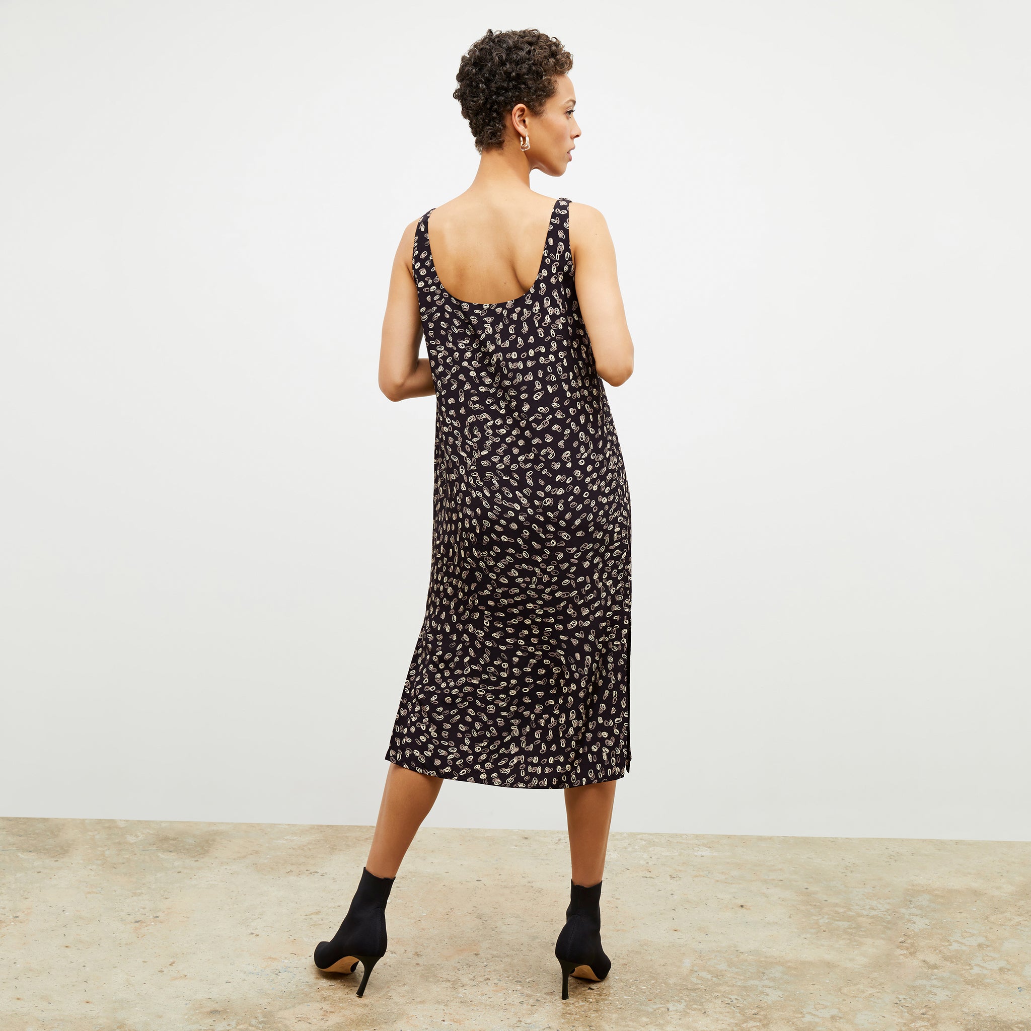 Back image of a woman wearing the Bevin Dress in Spin Dot