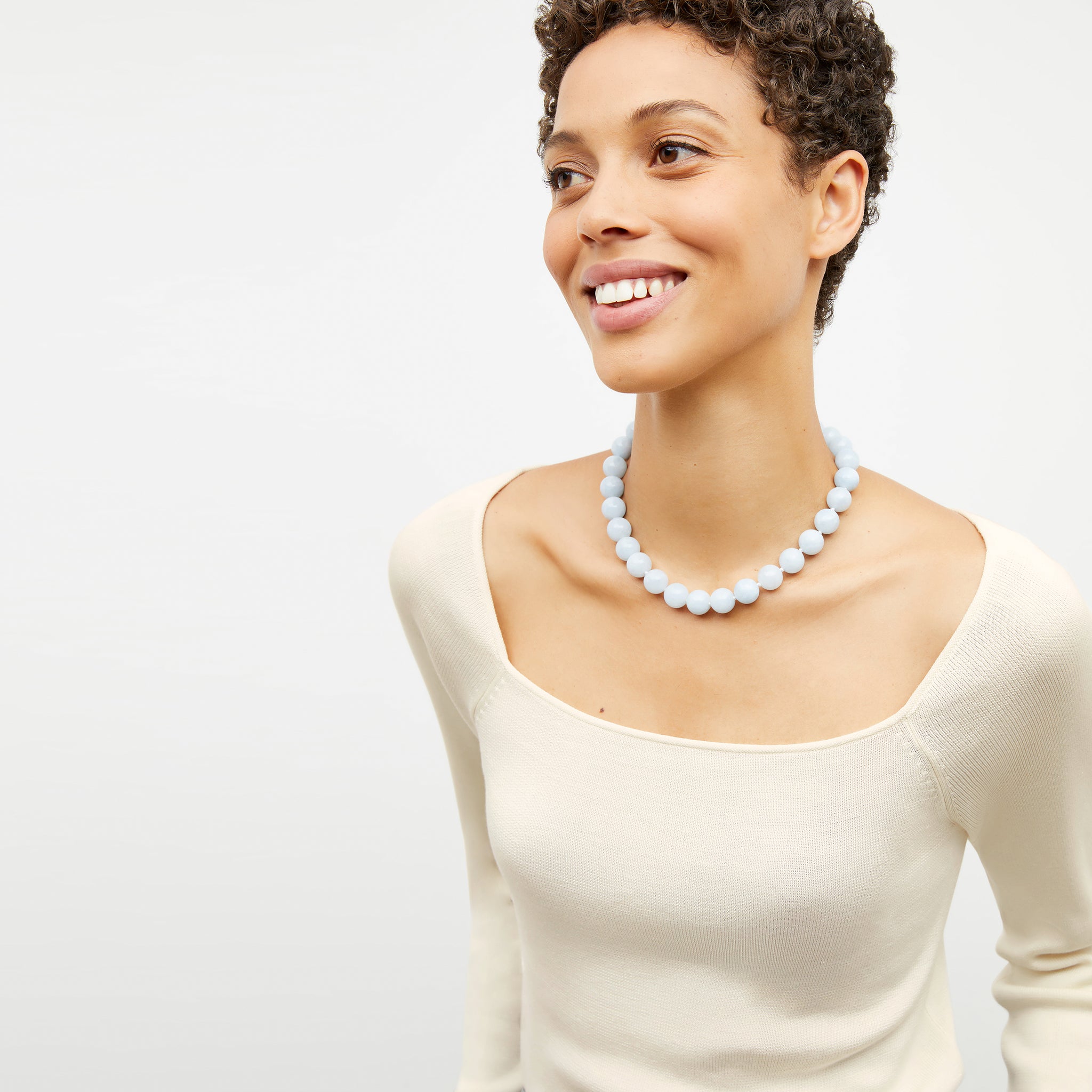 Front image of a woman wearing the leila necklace in blue jade