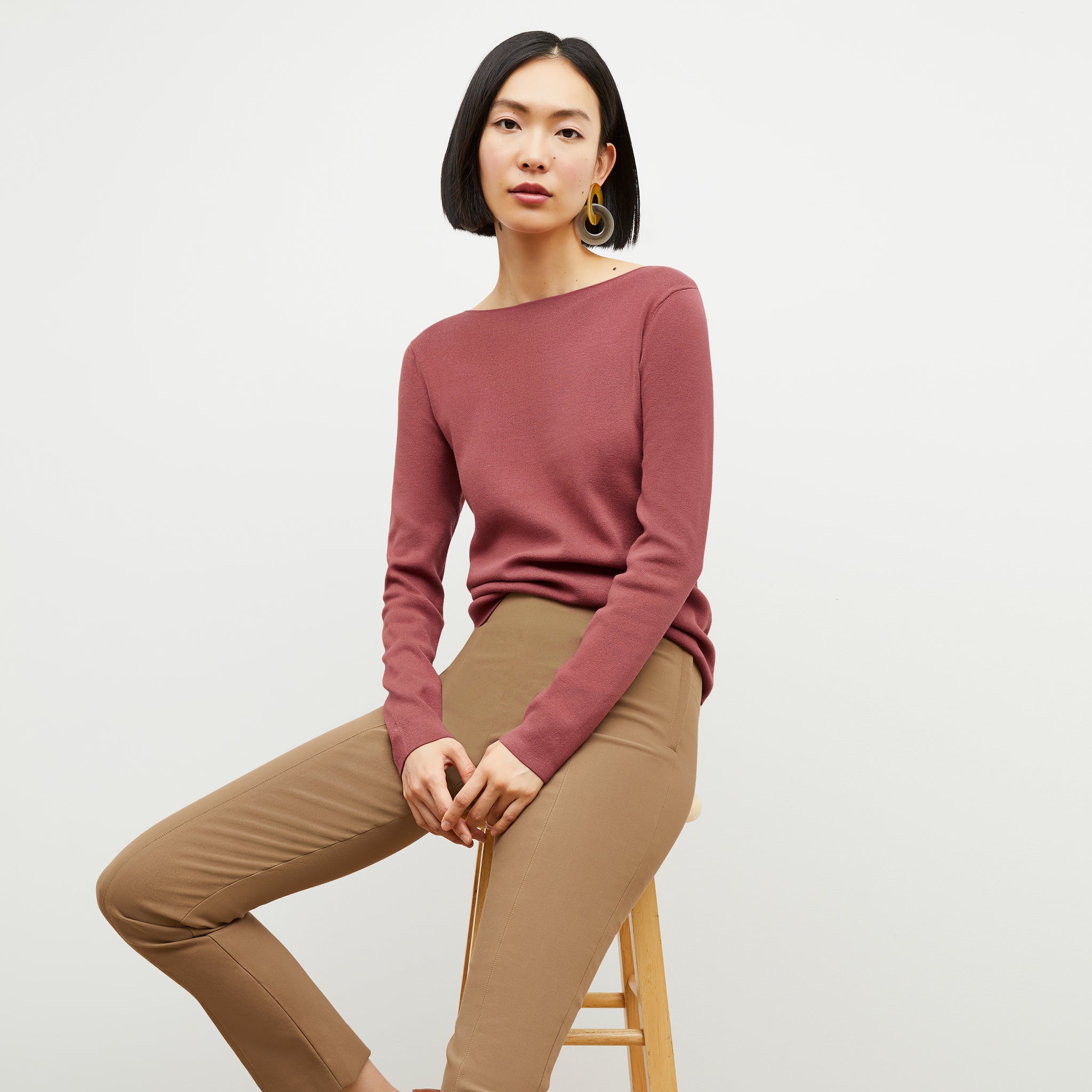 Front image of a woman wearing the Celeste top in dark coral 