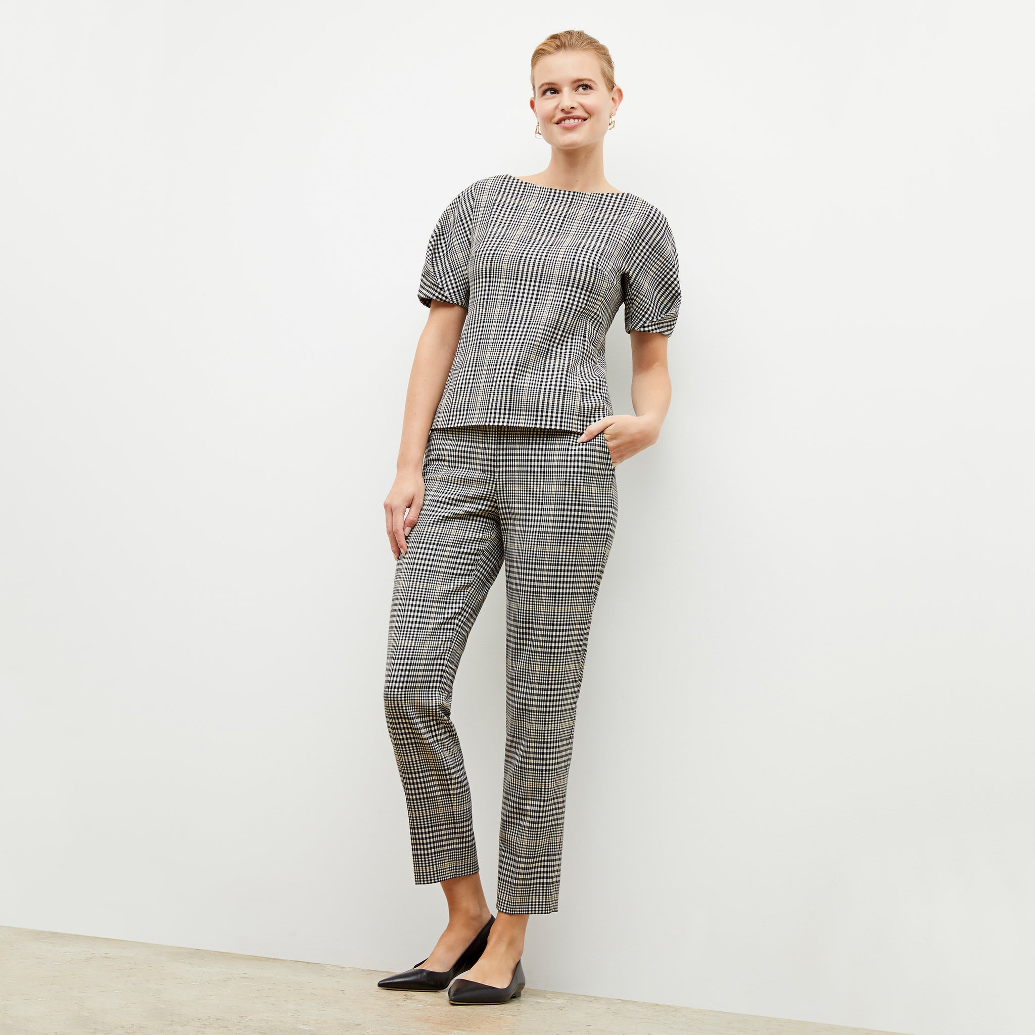 Front image of a woman wearing the mejia pant in plaid sharkskin