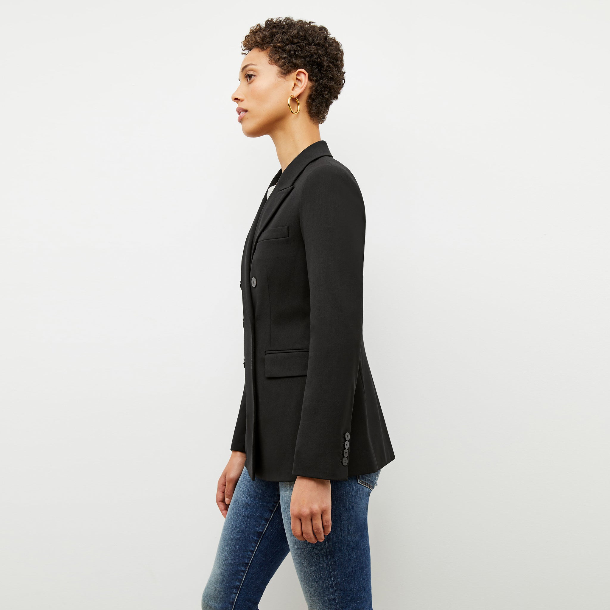 Side image of a woman wearing the kati jacket in black
