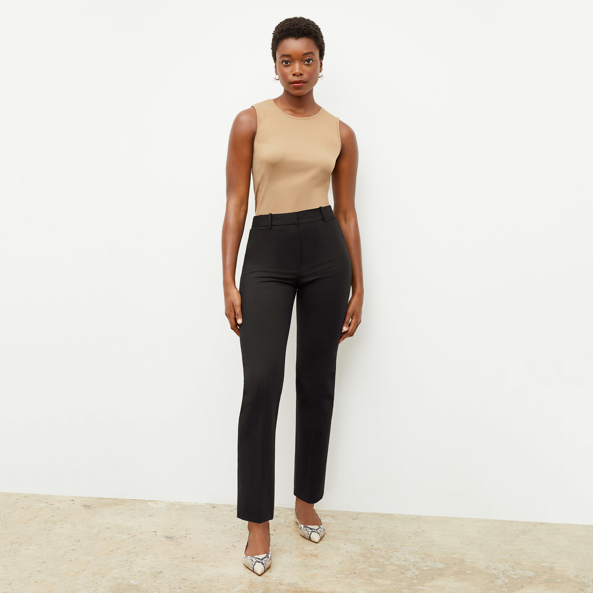 Front image of a woman wearing the smith pant in black