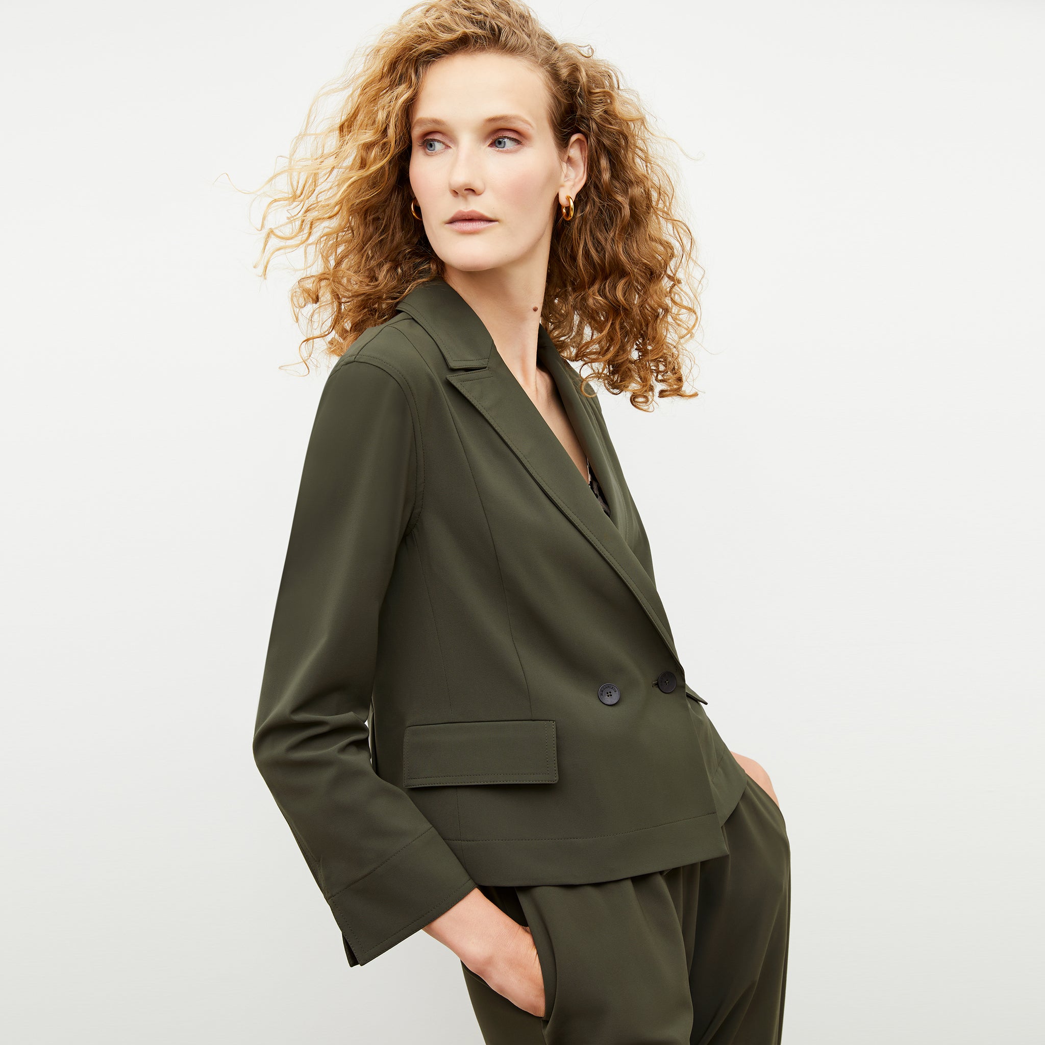 Front image of a woman wearing the nia jacket in olive