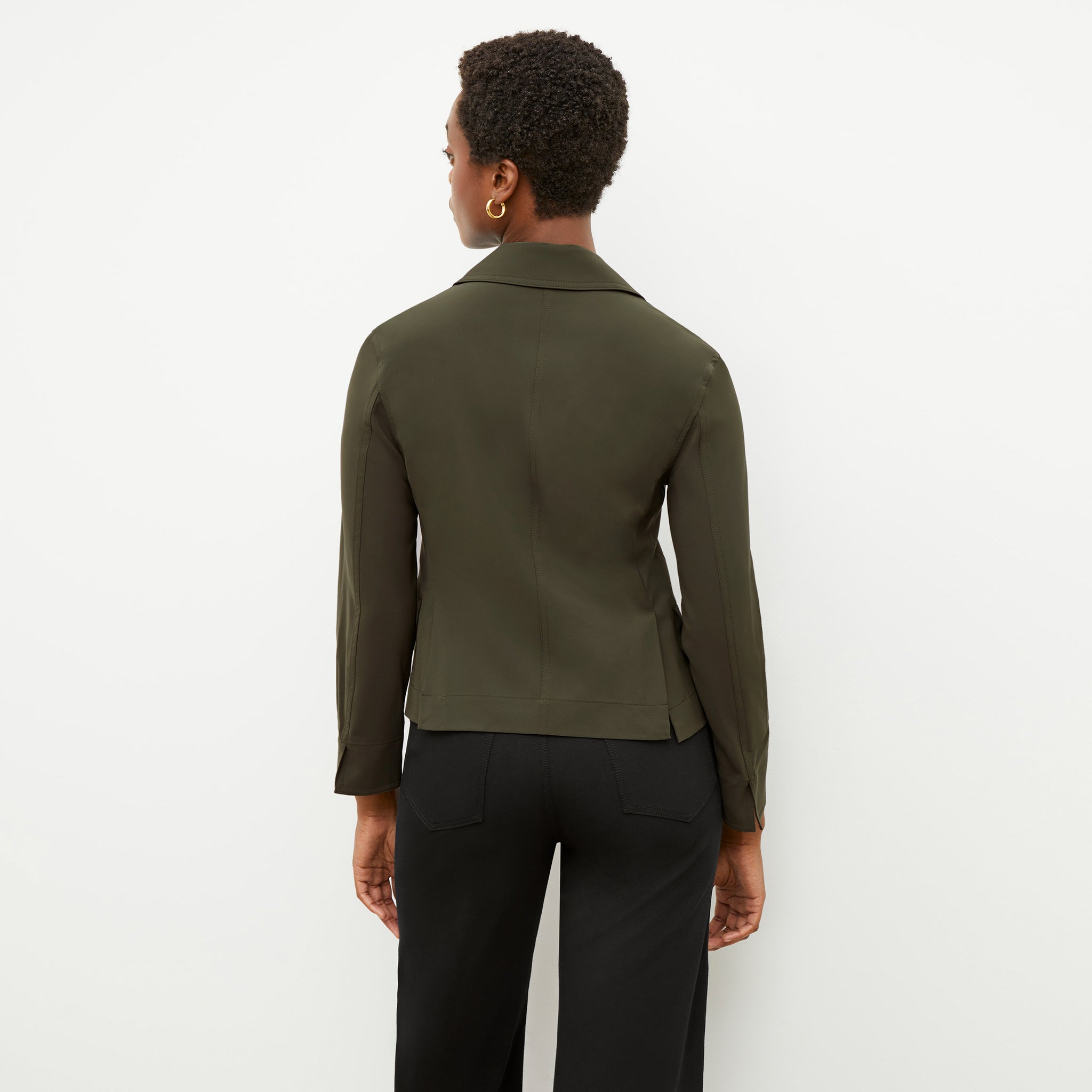 Back image of a woman wearing the nia jacket in olive