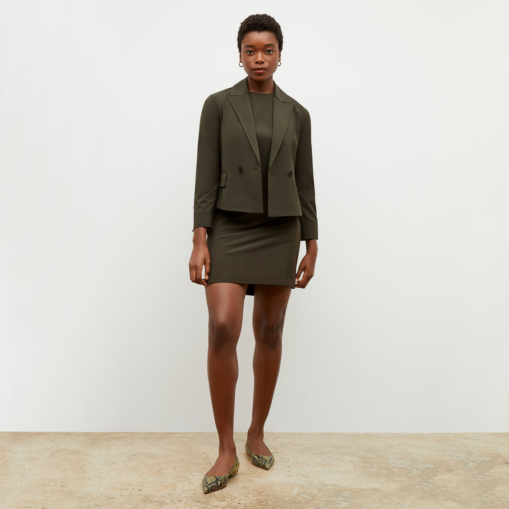 Front image of a woman wearing the nia jacket in olive