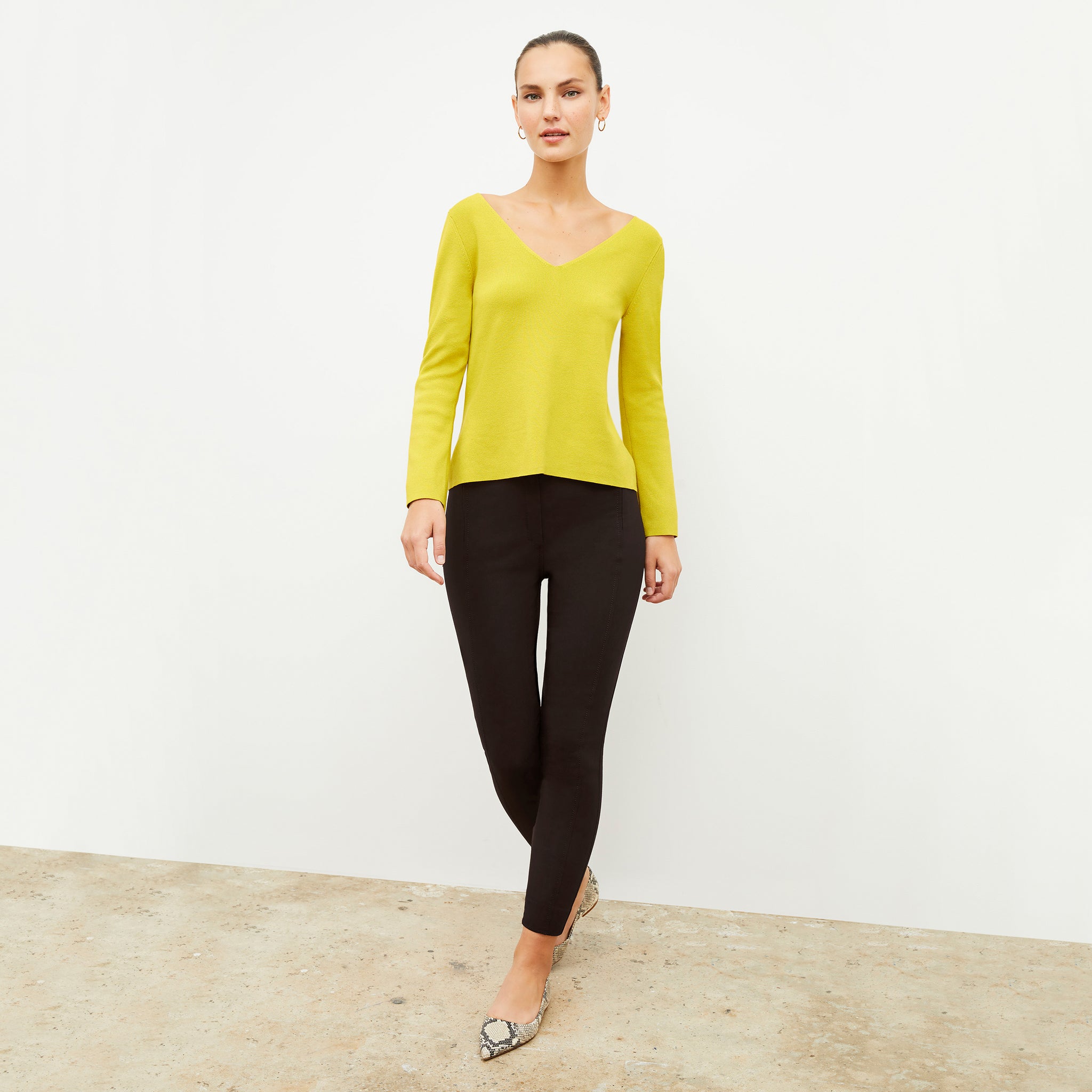 Front image of a woman wearing the kara top in chartreuse