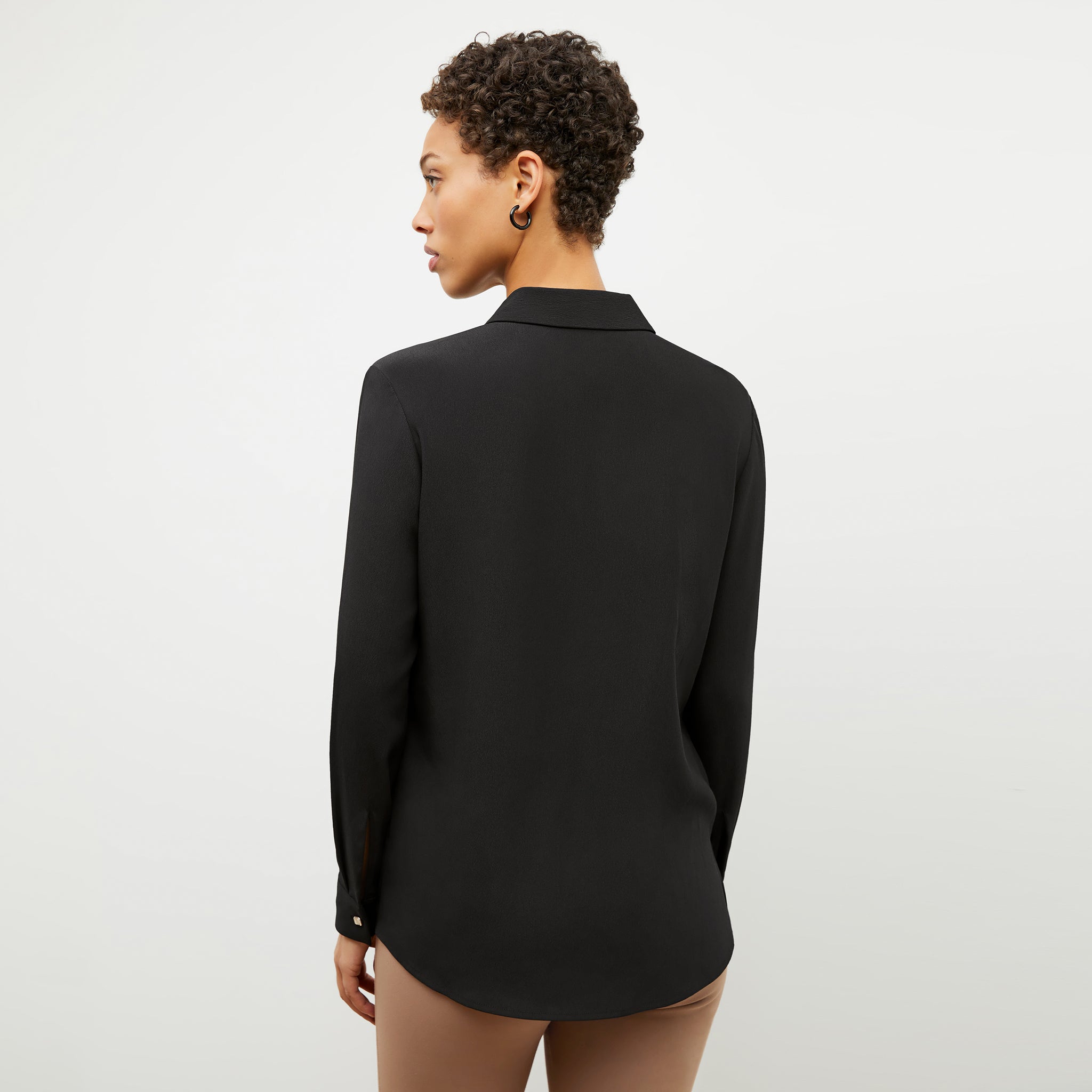 Back image of a woman wearing the lagarde shirt in black