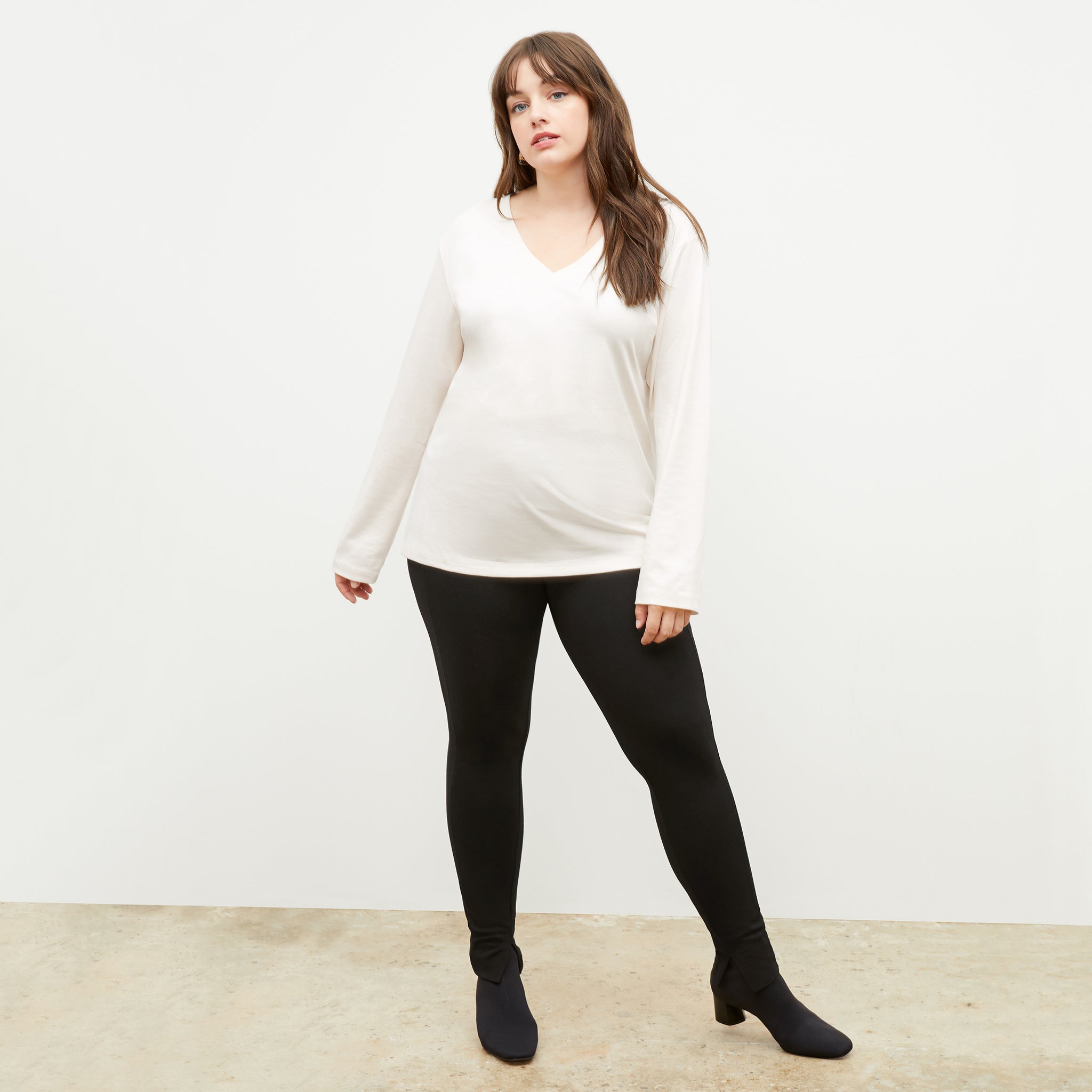 Front image of a woman standing wearing the stella legging in black