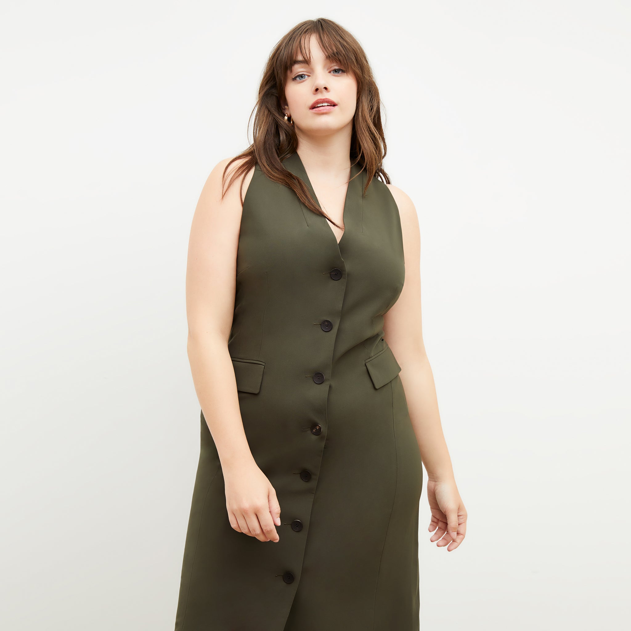 Back image of a woman wearing the Cassandra dress in origamitech in olive