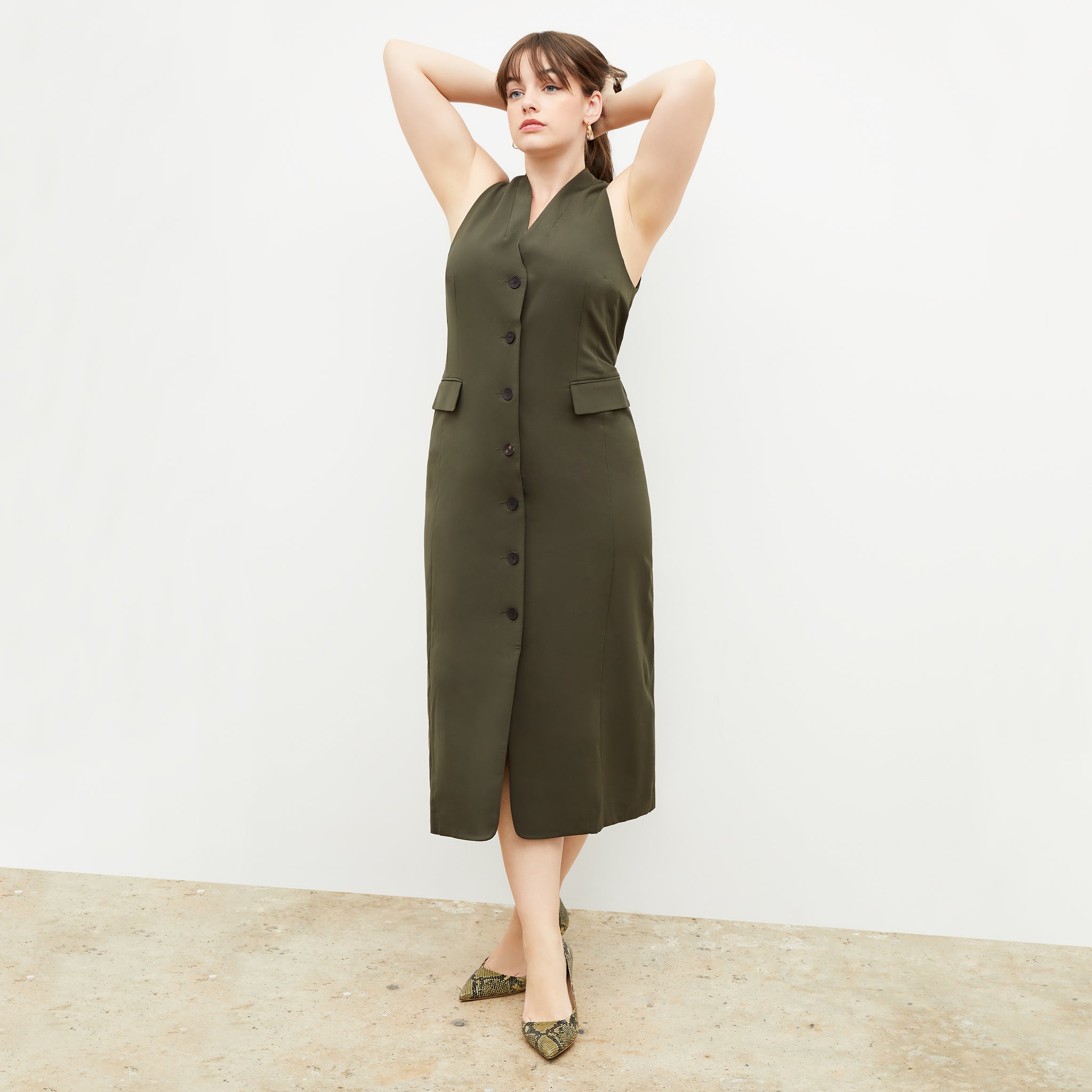 Back image of a woman wearing the Cassandra dress in origamitech in olive