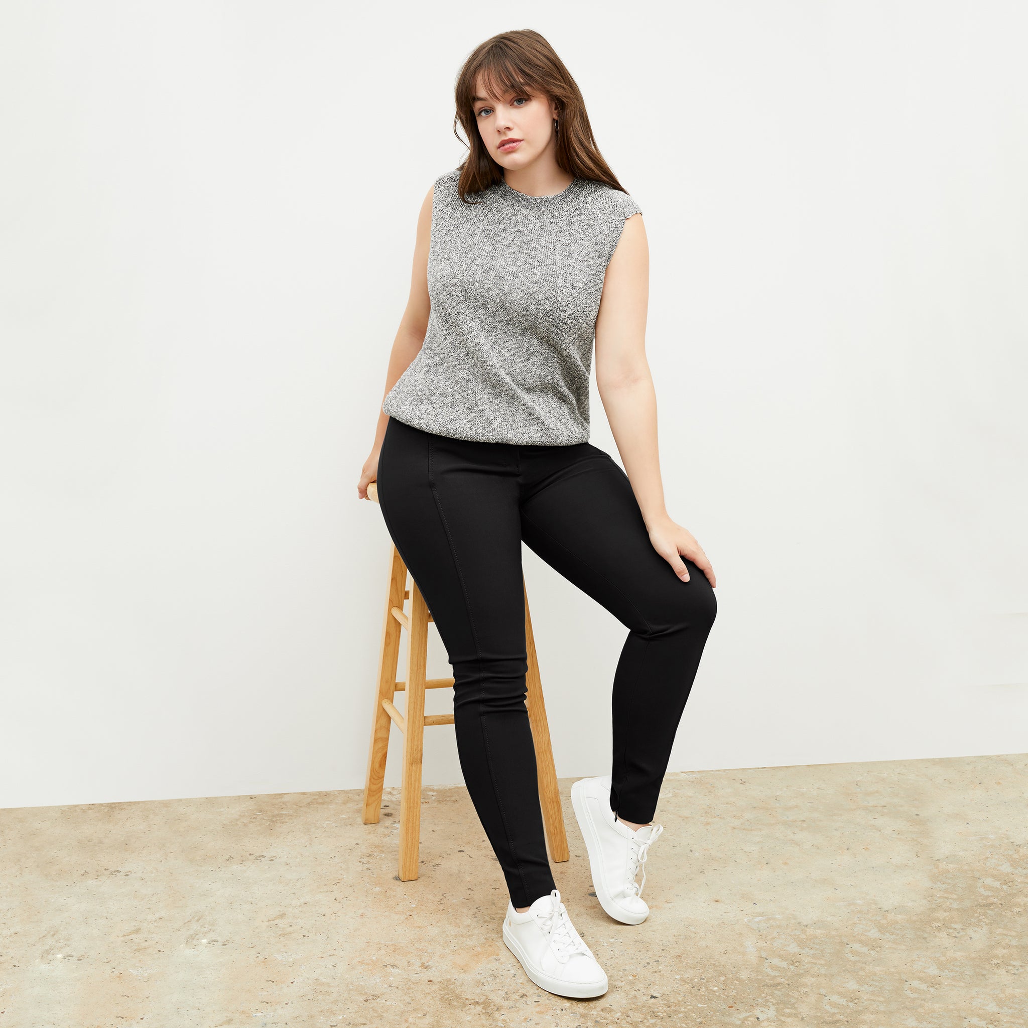 Front image of a woman standing wearing the Barbara Sweater—Knit Boucle in Black / White
