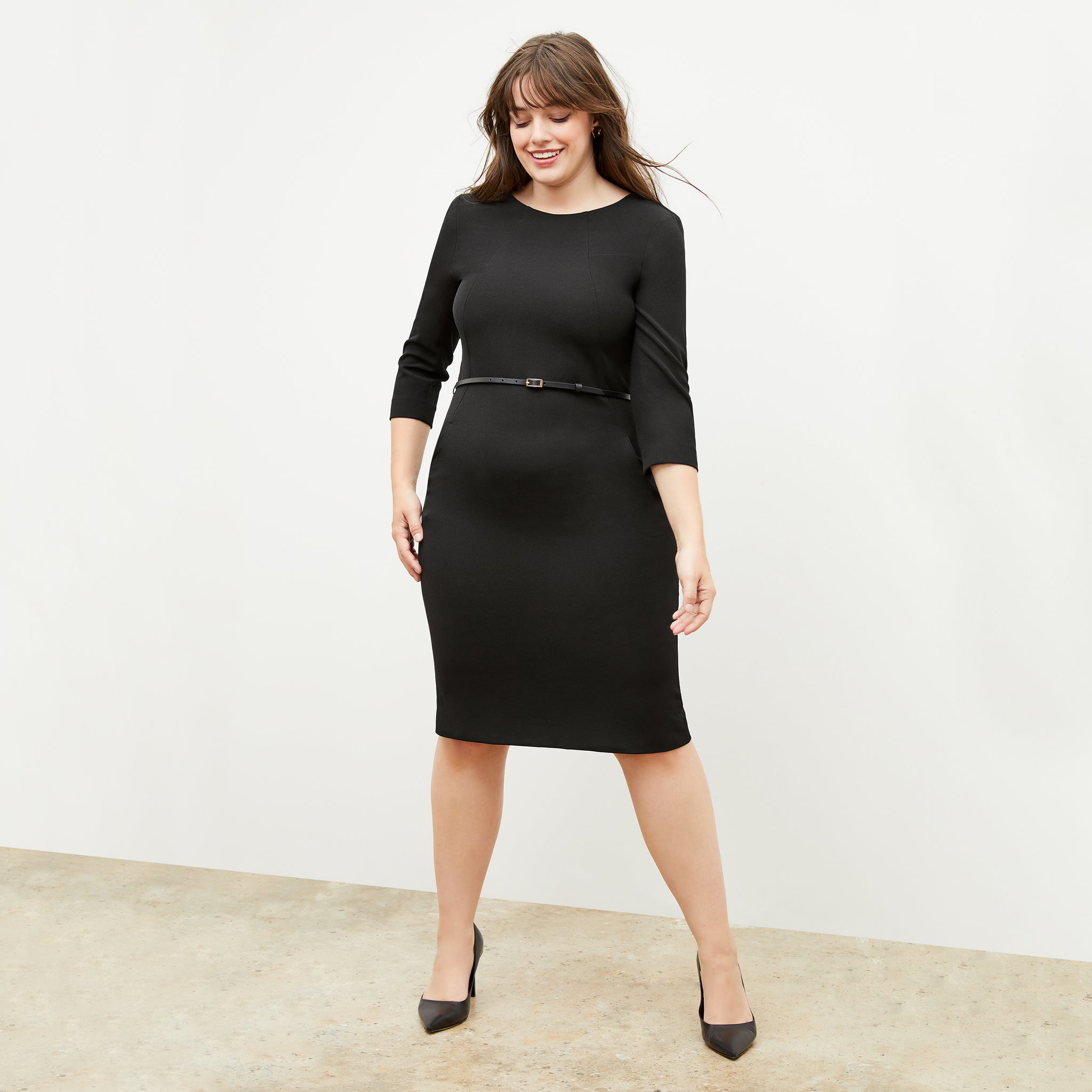 Front image of a woman standing wearing the Etsuko dress in black