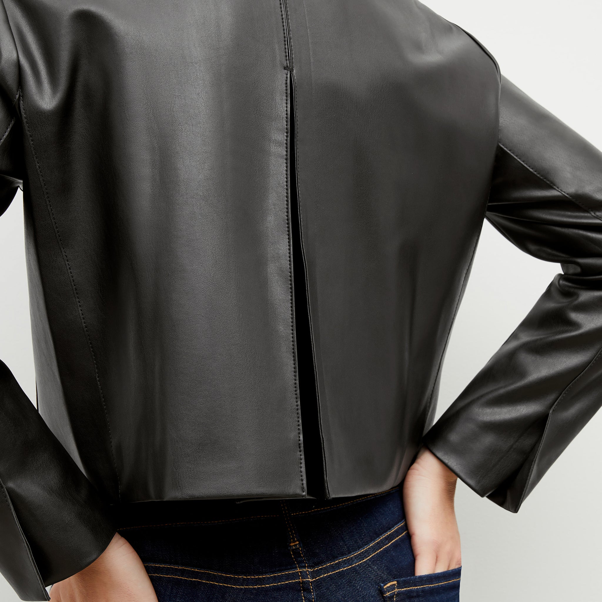 Back image of a woman wearing the nicky jacket in black