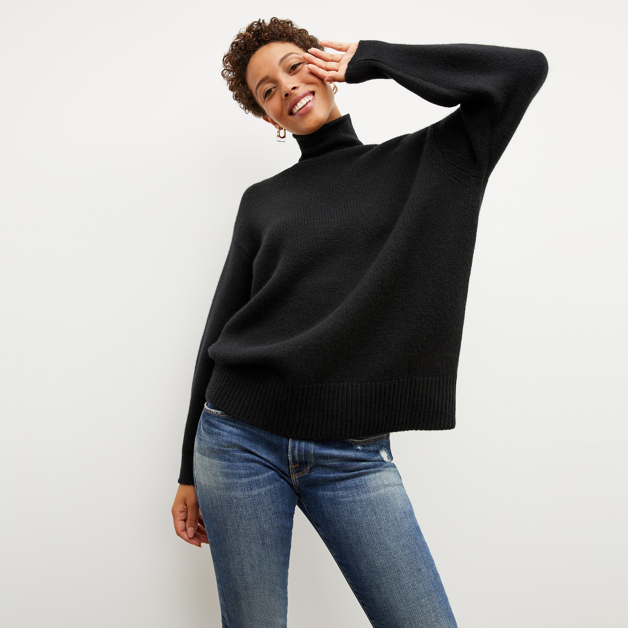 Front image of a woman wearing the lea sweater in black