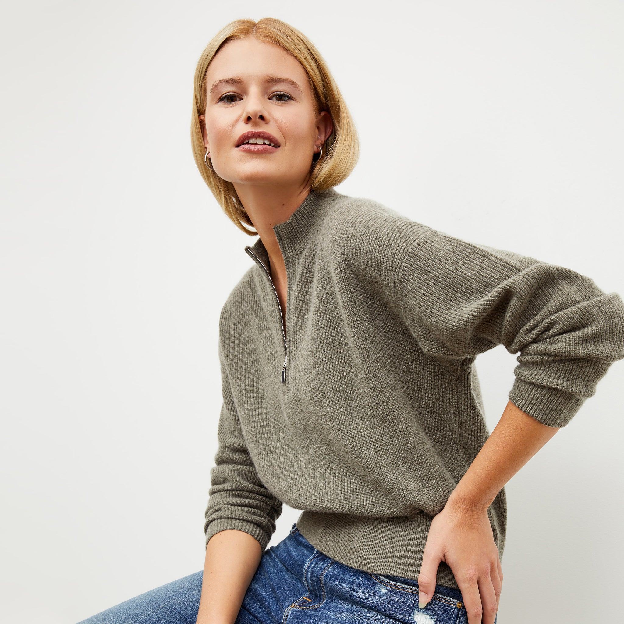 Front image of a woman wearing the cece sweater in dark moss 