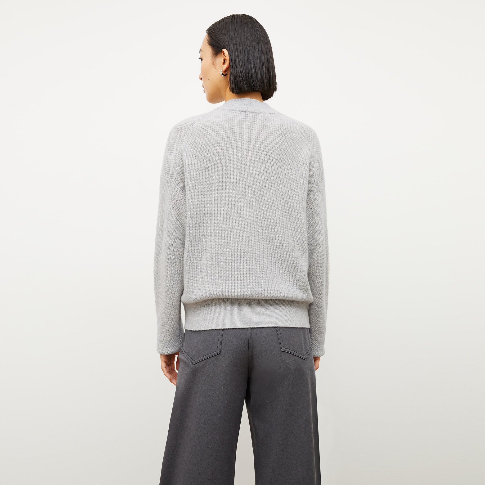 Back image of a woman wearing the cece sweater in light heather gray
