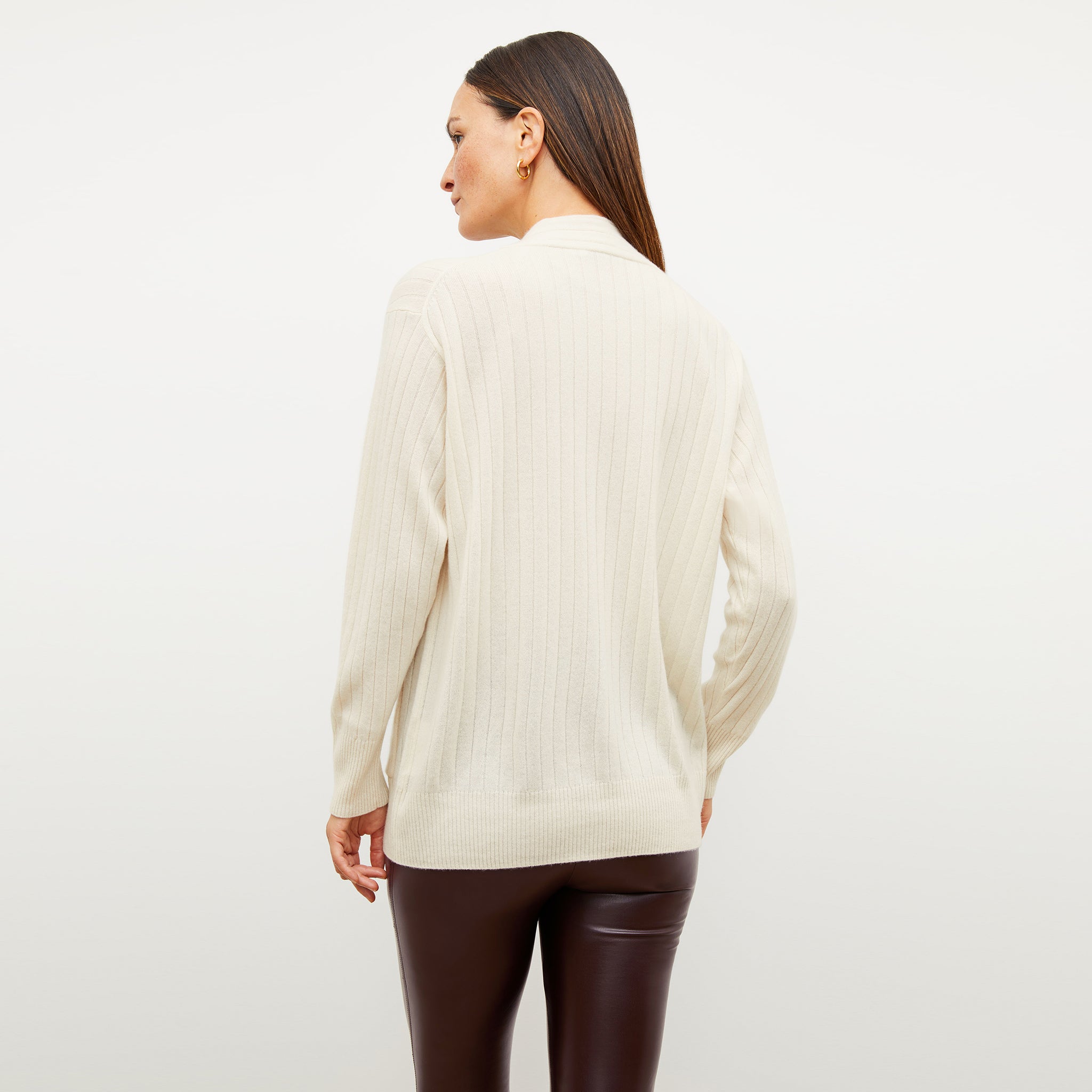 Back image of a woman wearing the caro sweater in light cream