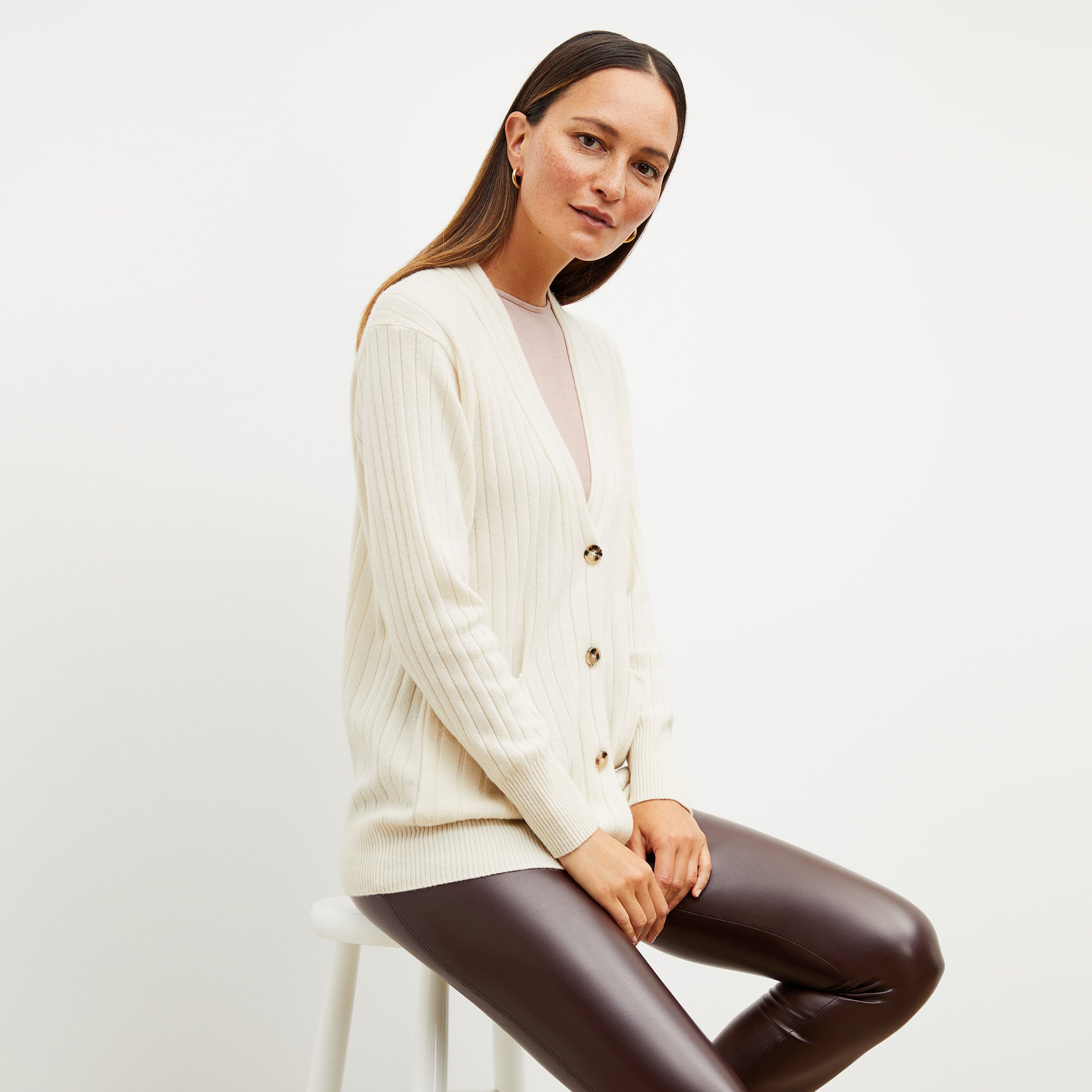 Front image of a woman wearing the caro sweater in light cream 