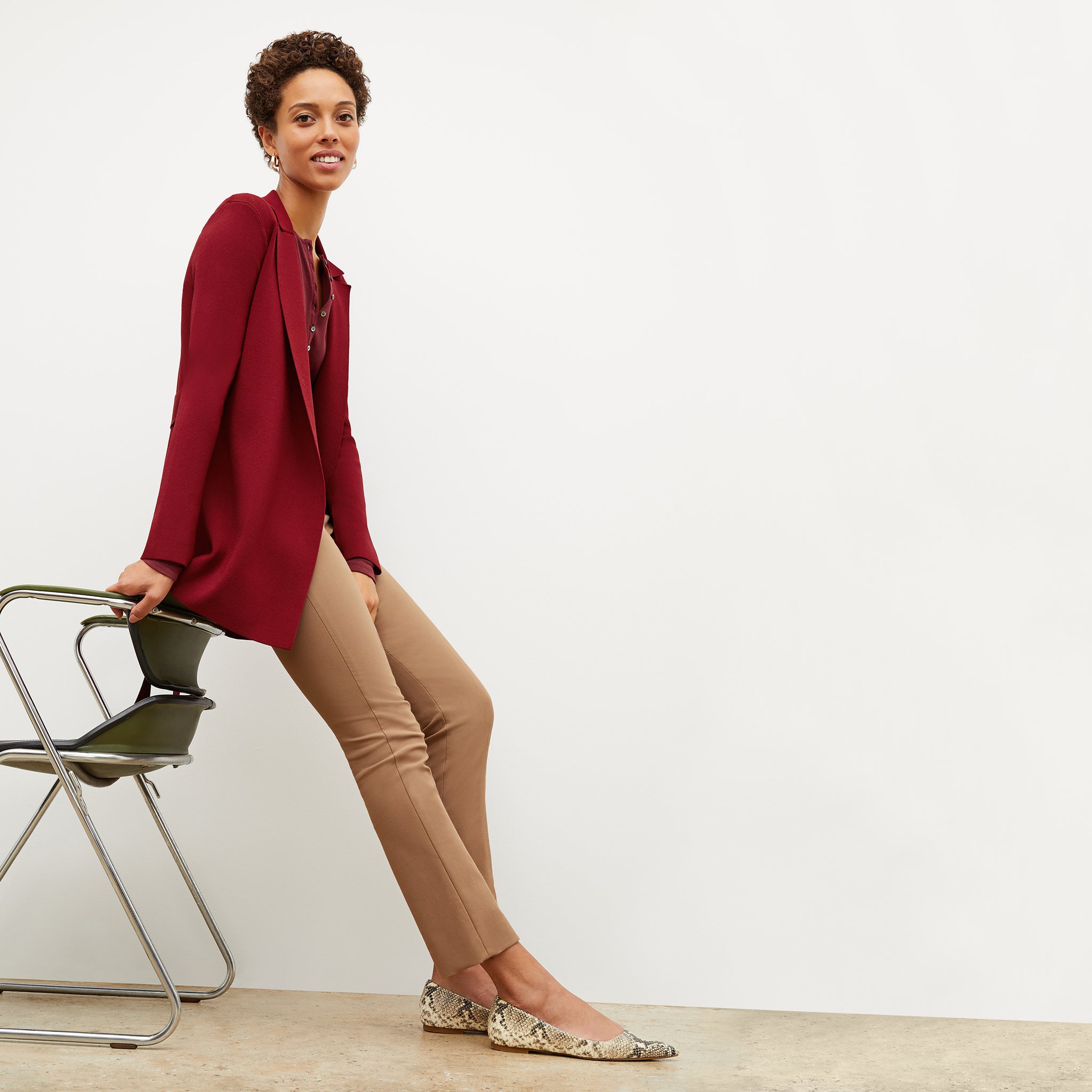 Front image of a woman sitting wearing the Foster Pant—Everstretch in Saddle