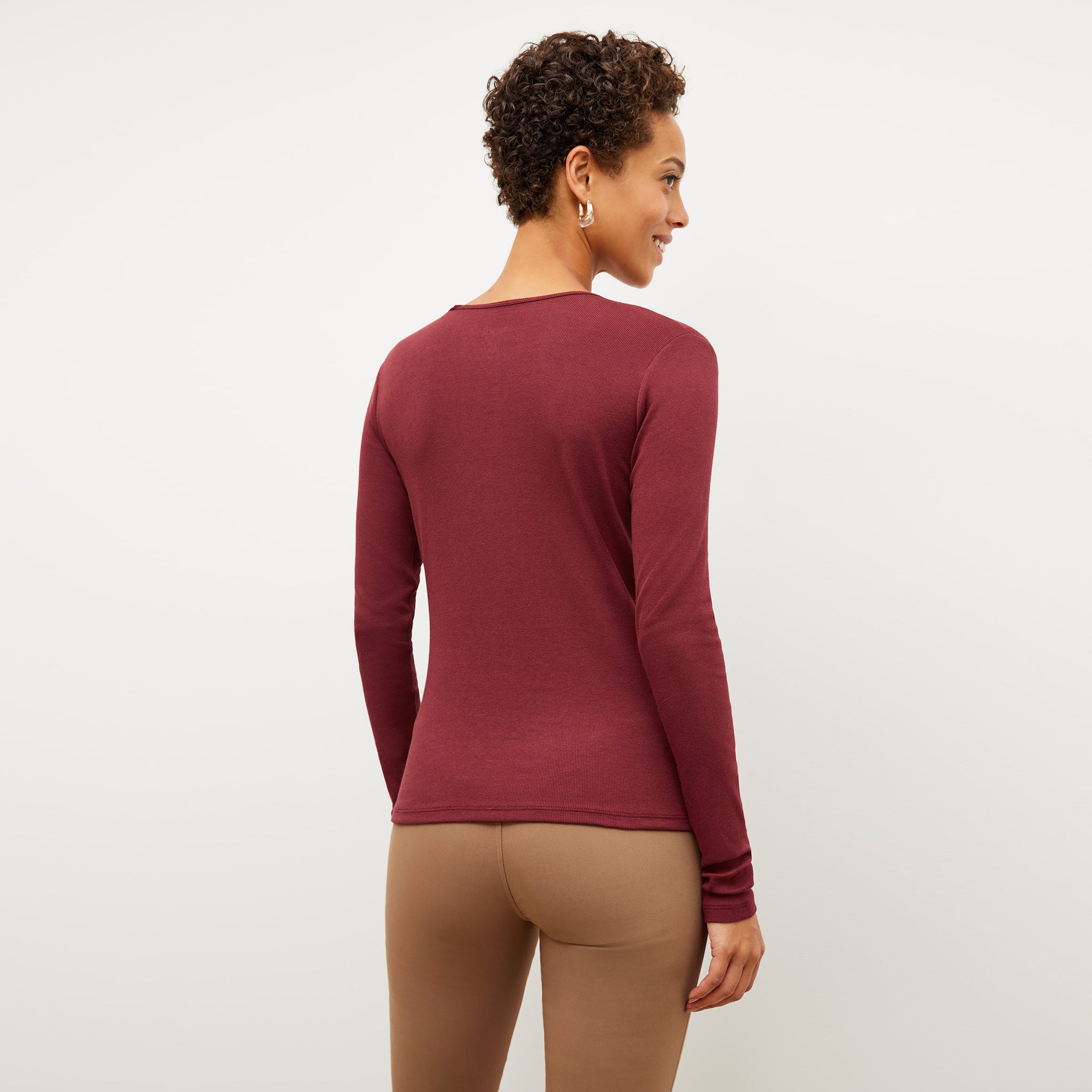 Image of a woman wearing the Remington Henley in Cranberry