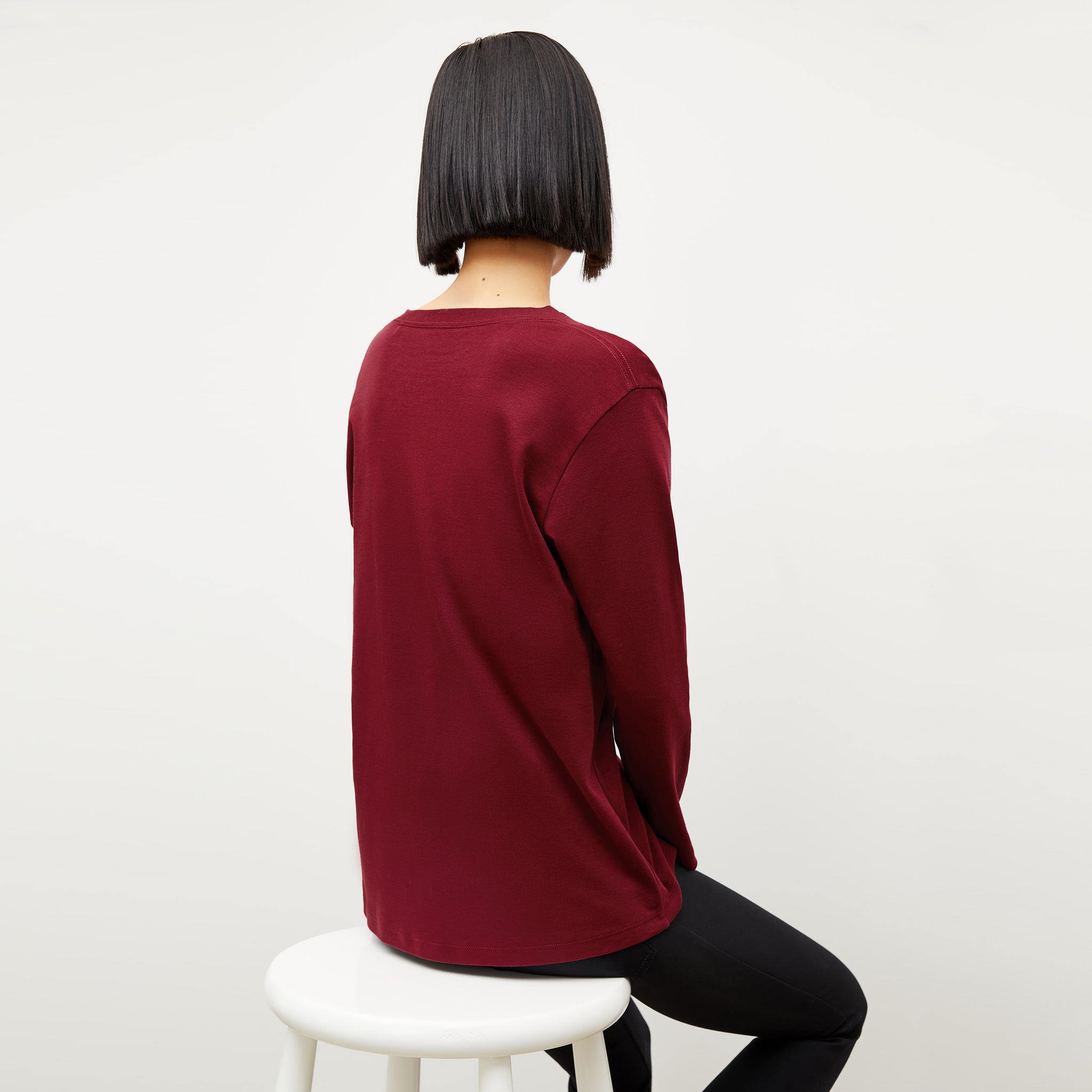 Back image of a woman wearing the asher shirt in maroon