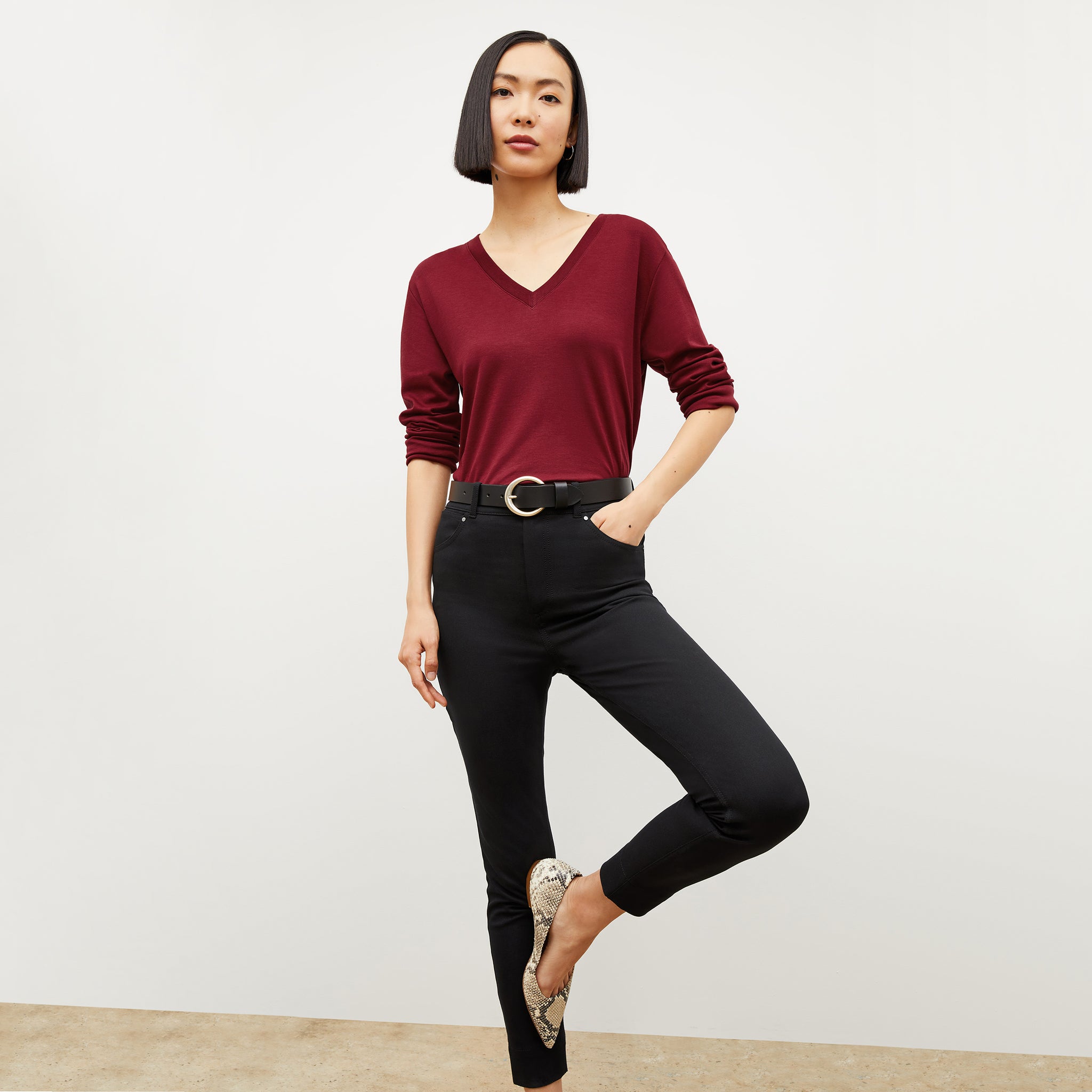 Front image of a woman wearing the asher shirt in maroon 