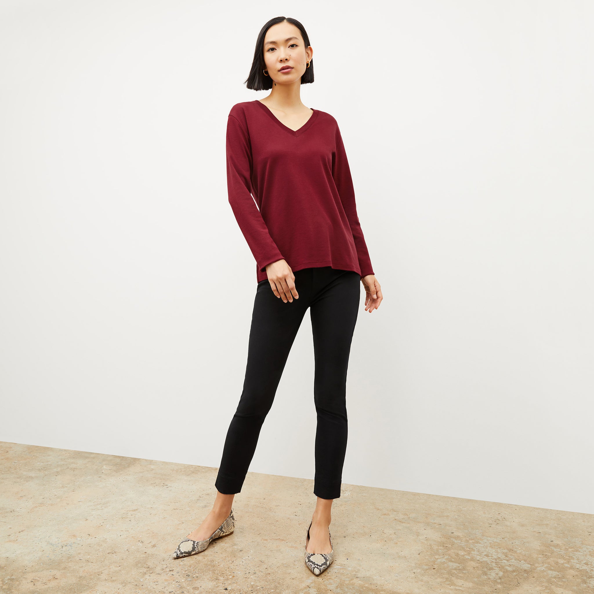 Front image of a woman wearing the asher shirt in maroon