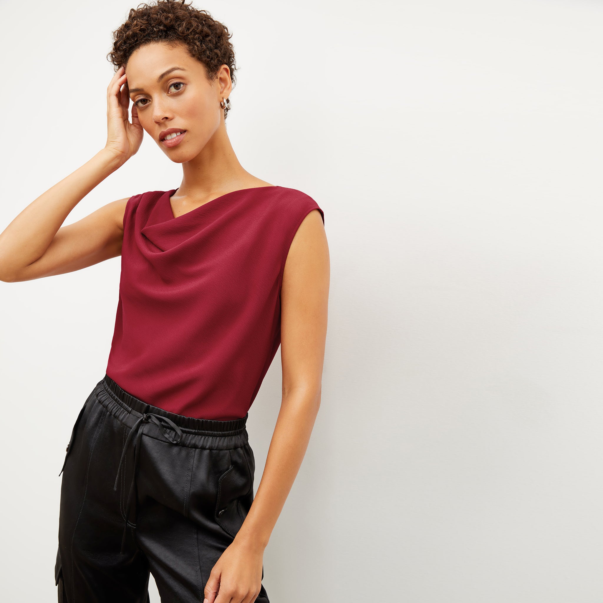 Front image of a woman wearing the nora top in cerise 