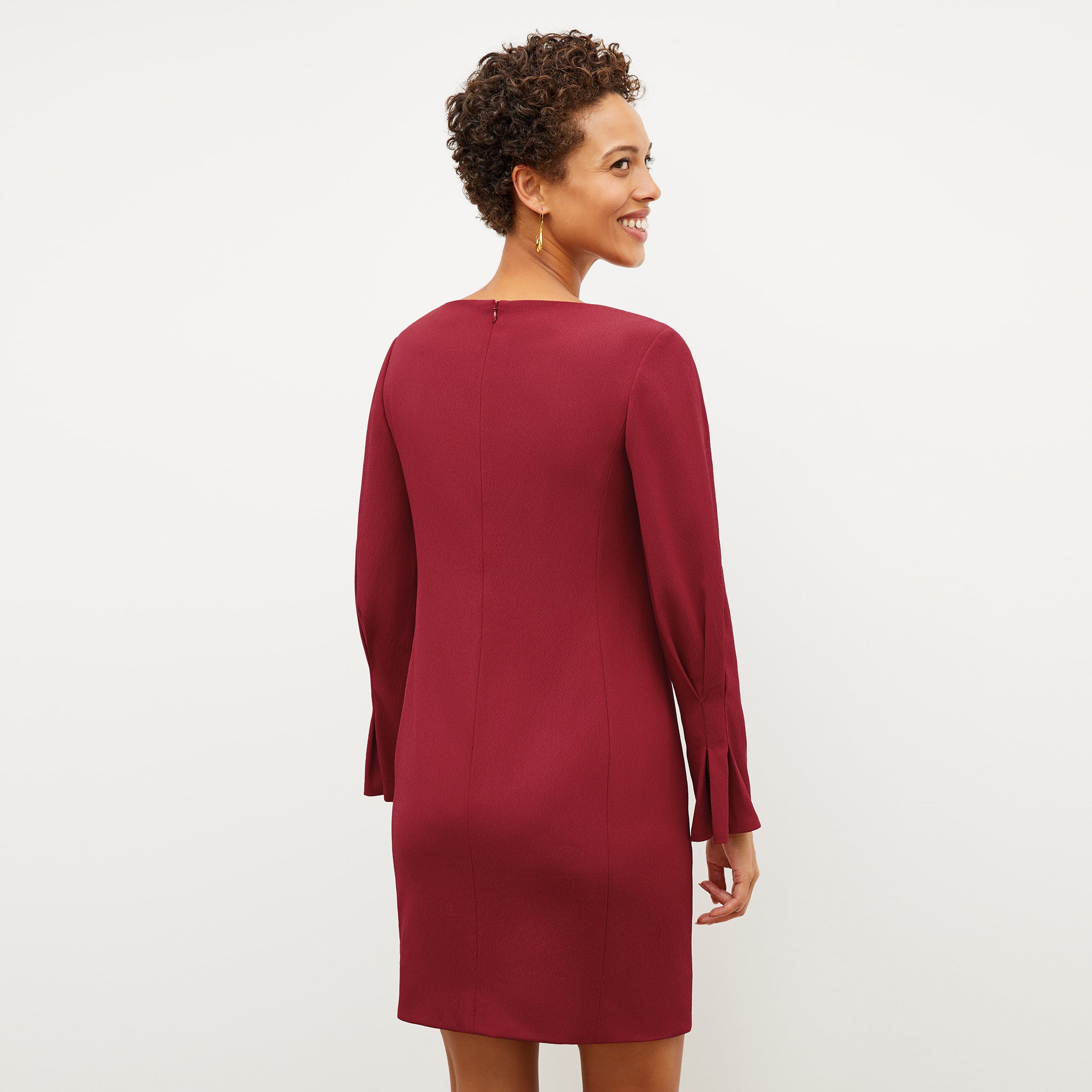 Back image of a woman wearing the regina dress in cerise