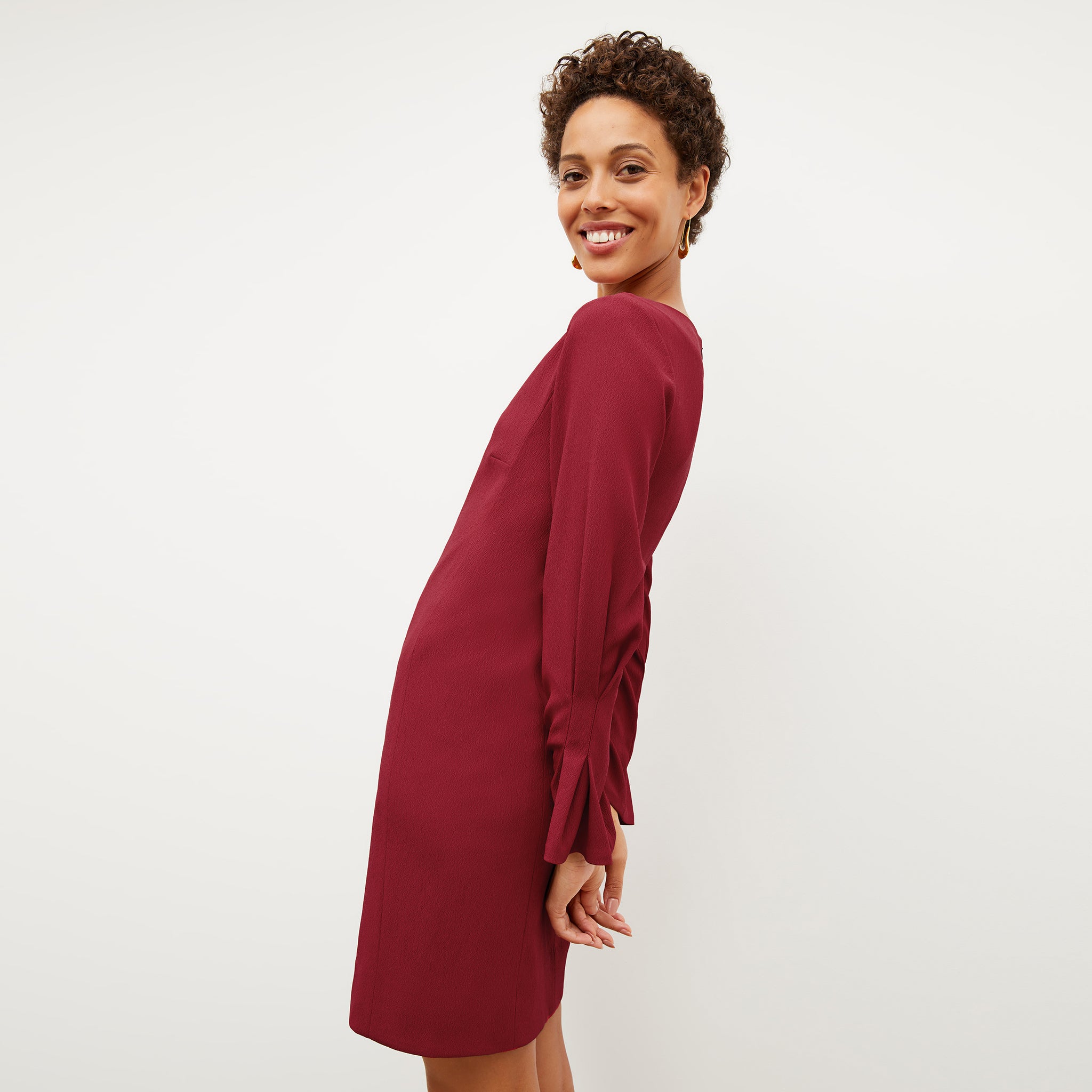 Front image of a woman wearing the regina dress in cerise