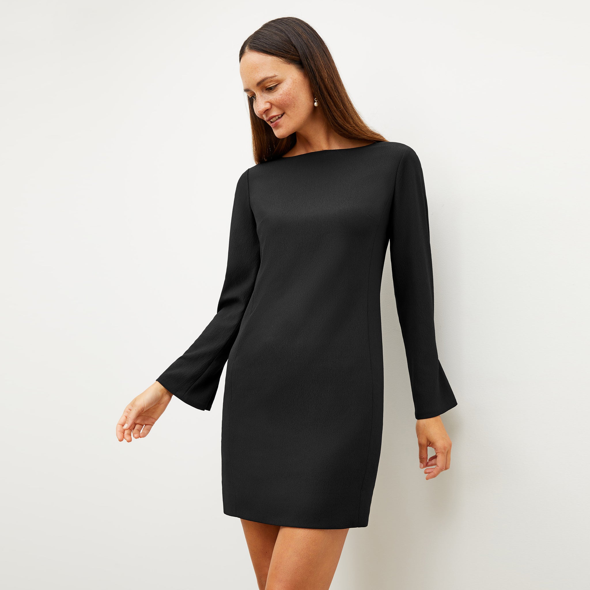 Front image of a woman wearing the regina dress in black