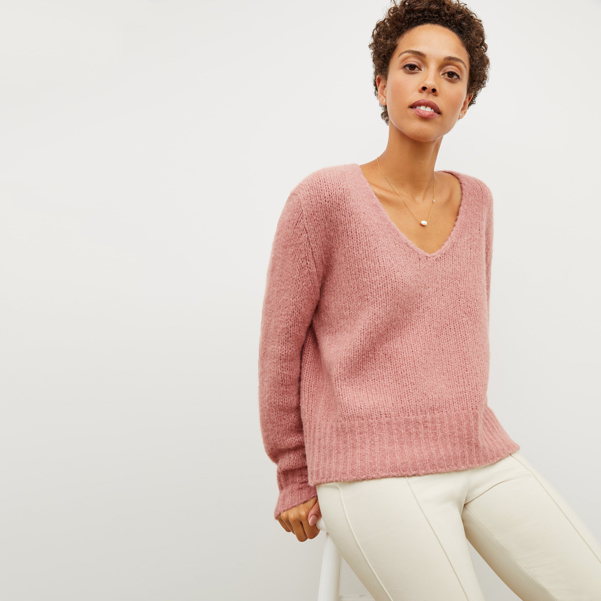 Front image of a woman wearing the cathy sweater in himilayan salt 