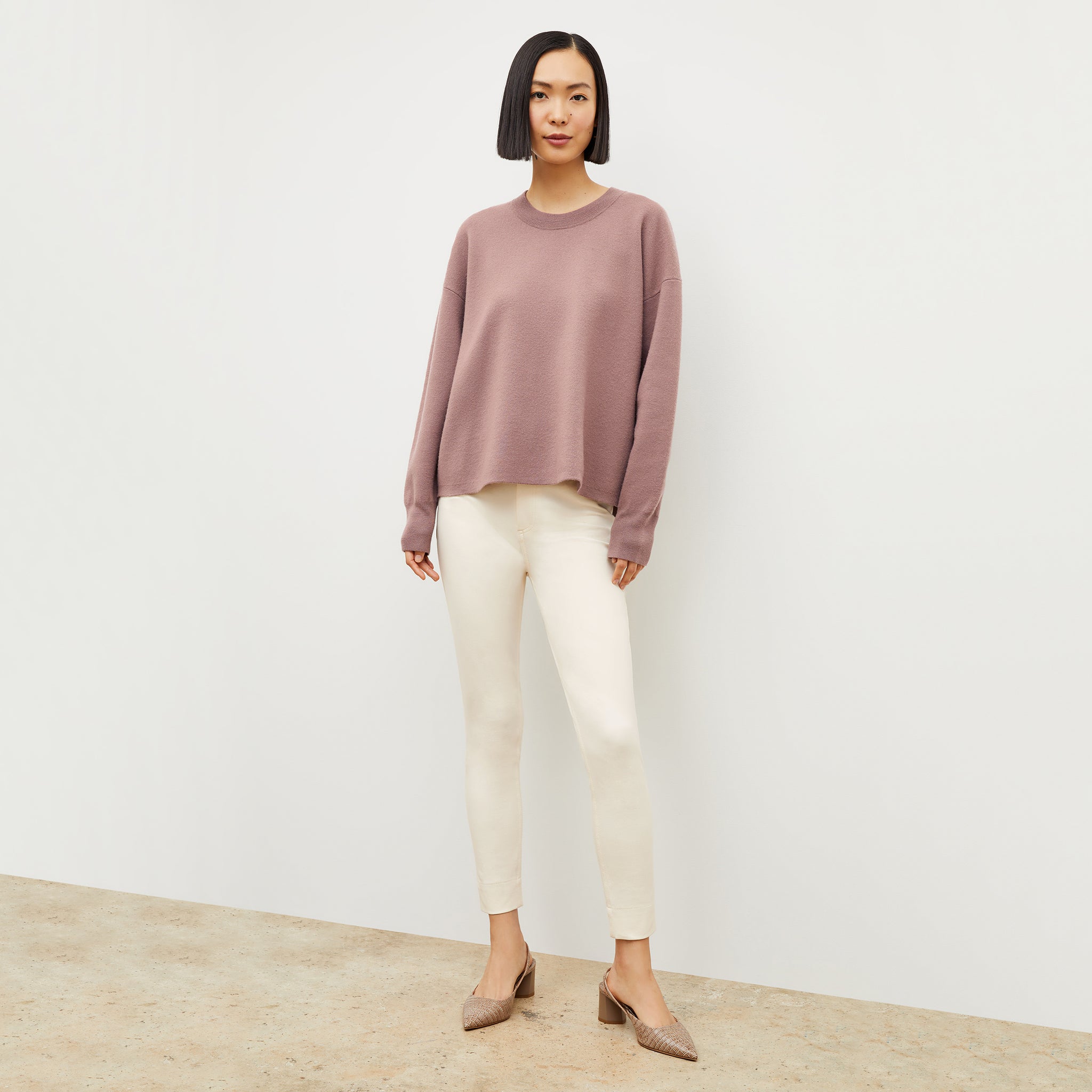 Front image of a woman wearing the quincy sweater in rose taupe