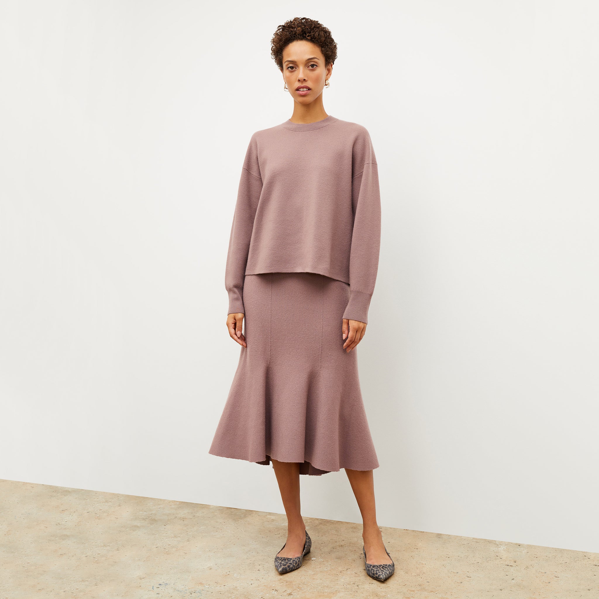 Front image of a woman wearing the leah skirt in rose taupe 