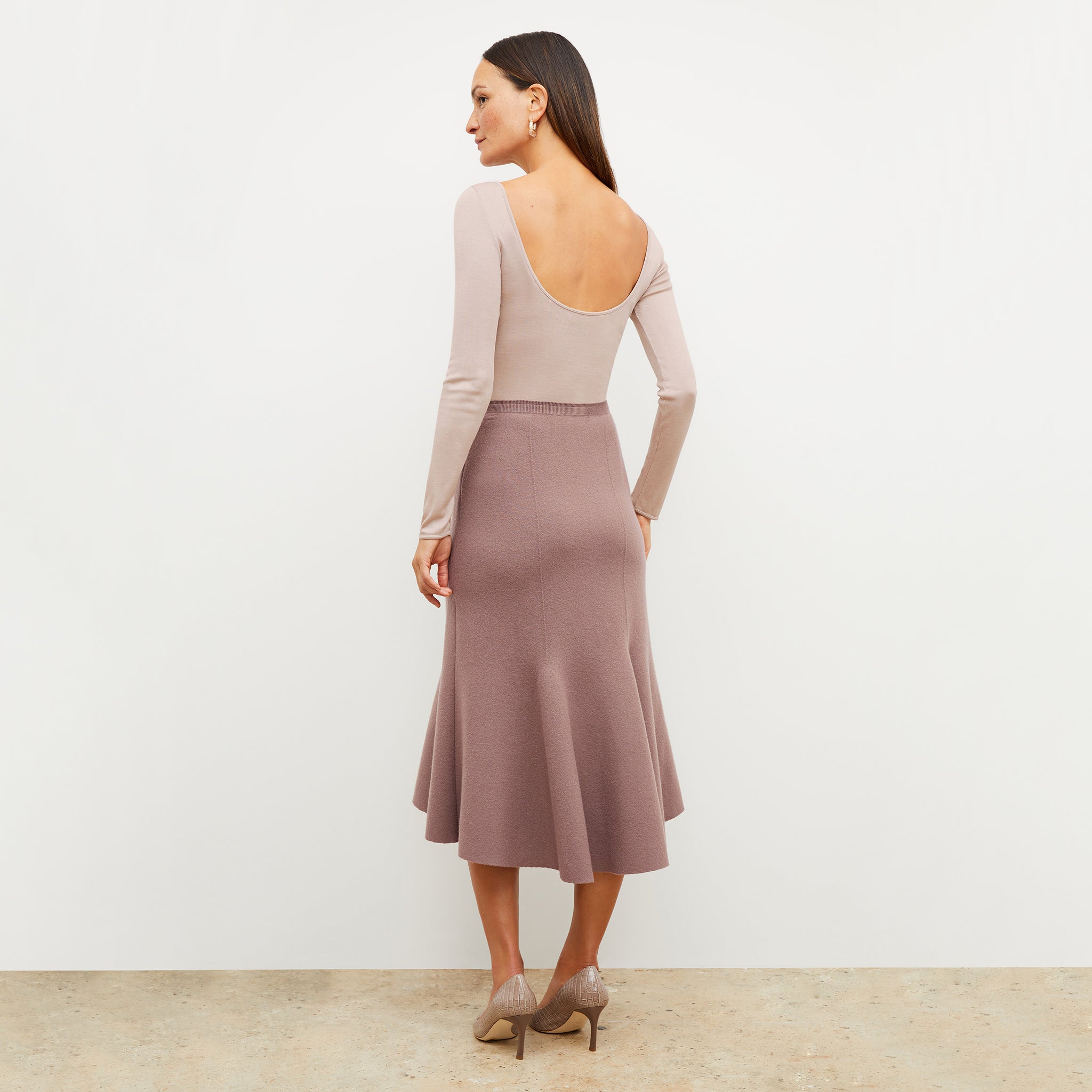 Back image of a woman wearing the leah skirt in rose taupe 