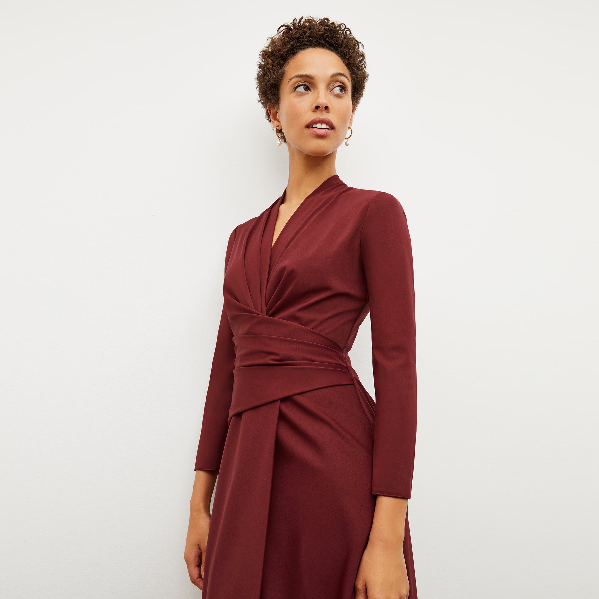 Front image of a woman wearing the carly dress in maroon