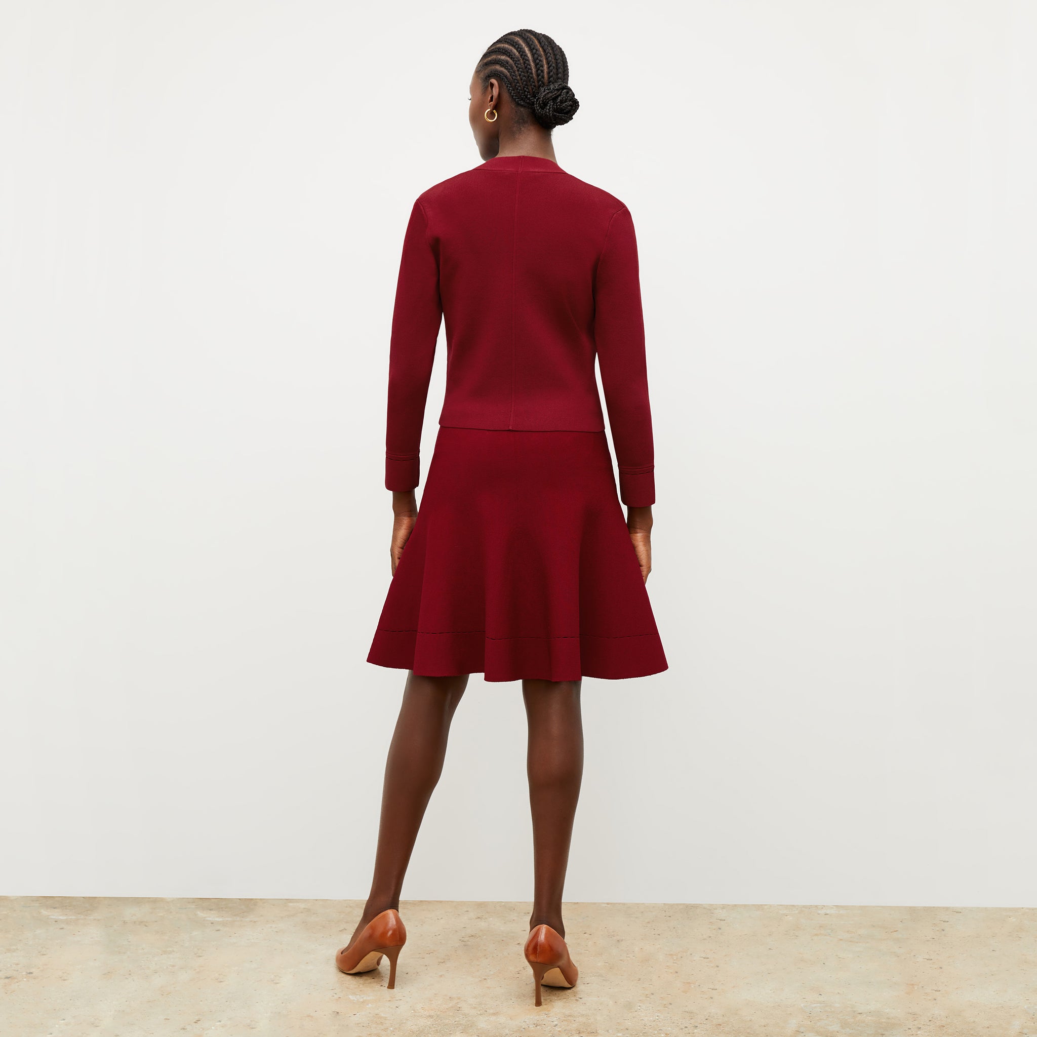 Front image of a woman wearing the luca skirt in maroon