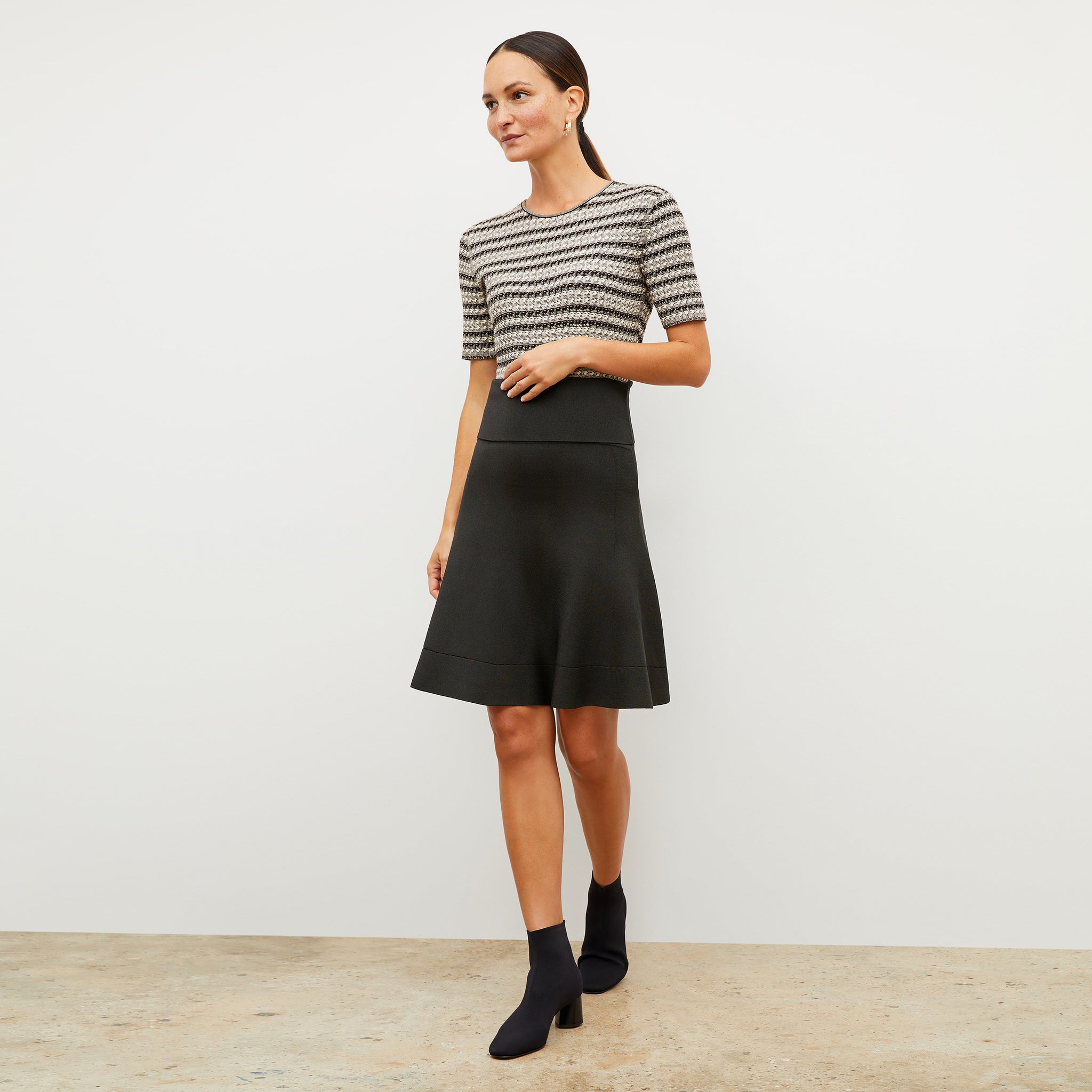 Front image of a woman wearing the luca skirt in black 