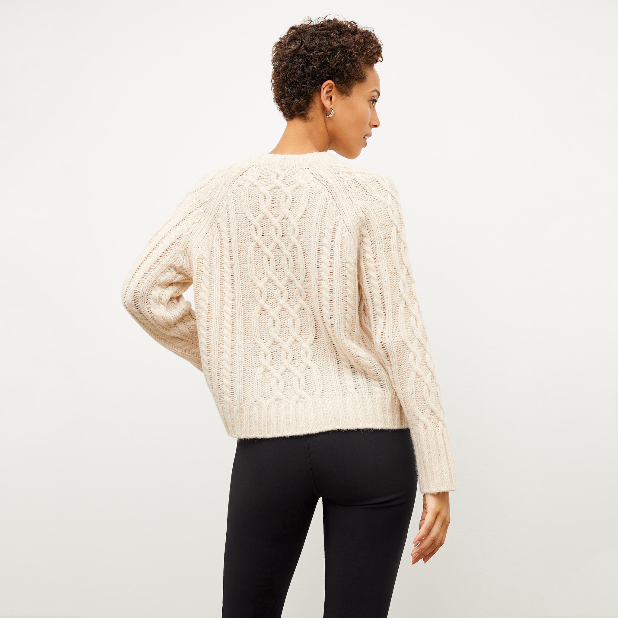 Image of a woman wearing the somers sweater in ivory