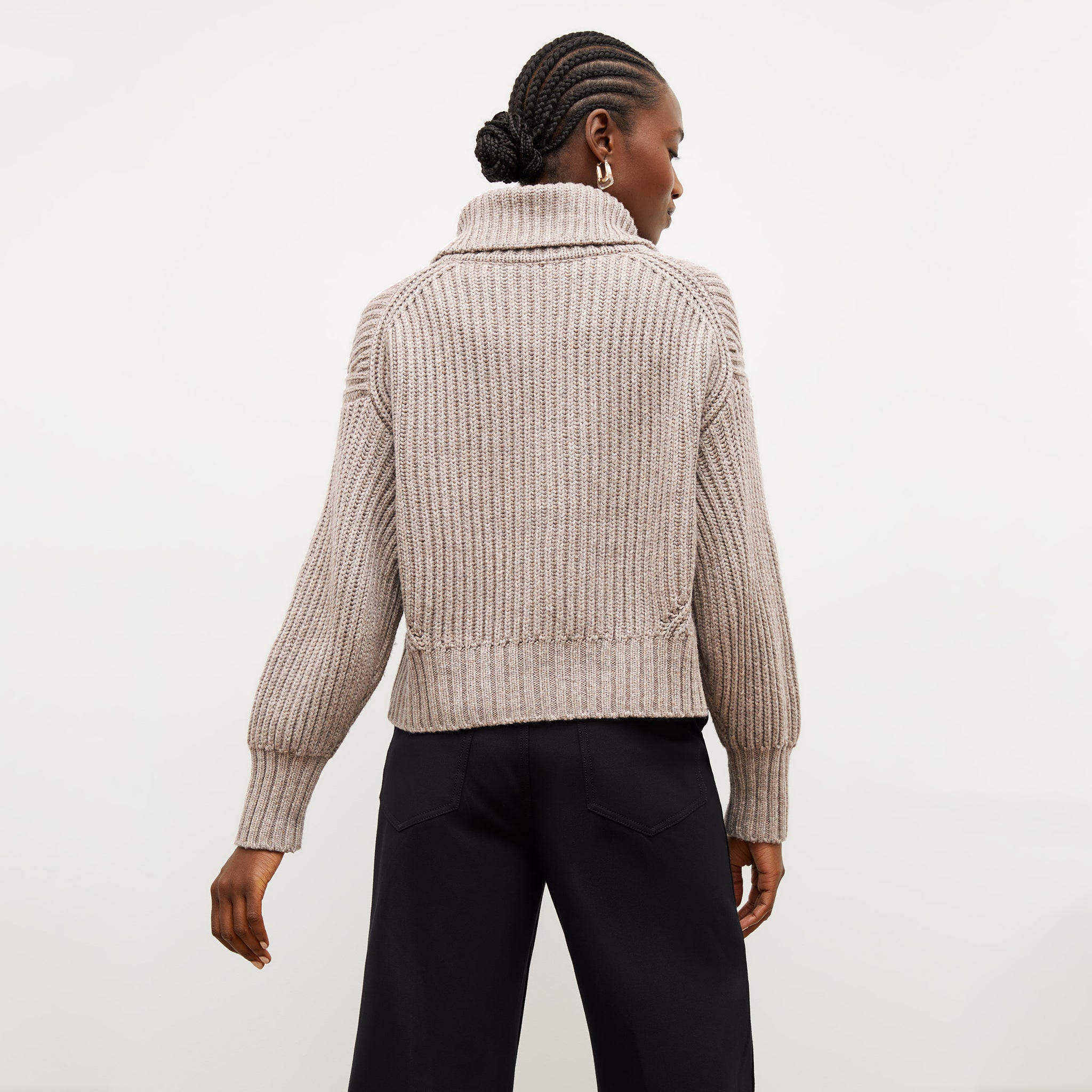 Back image of a woman wearing the william sweater in barley