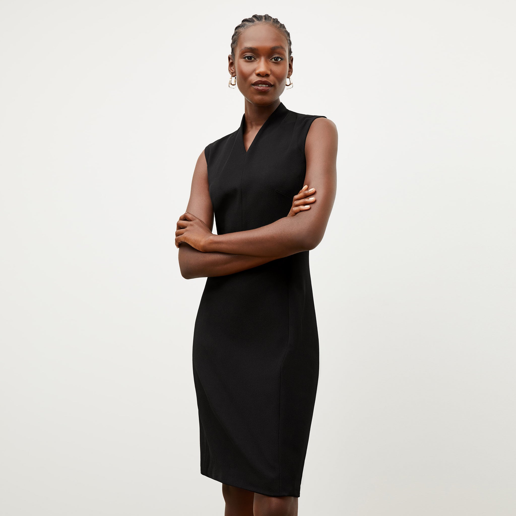 Front image of a woman standing wearing the Aditi dress in black 