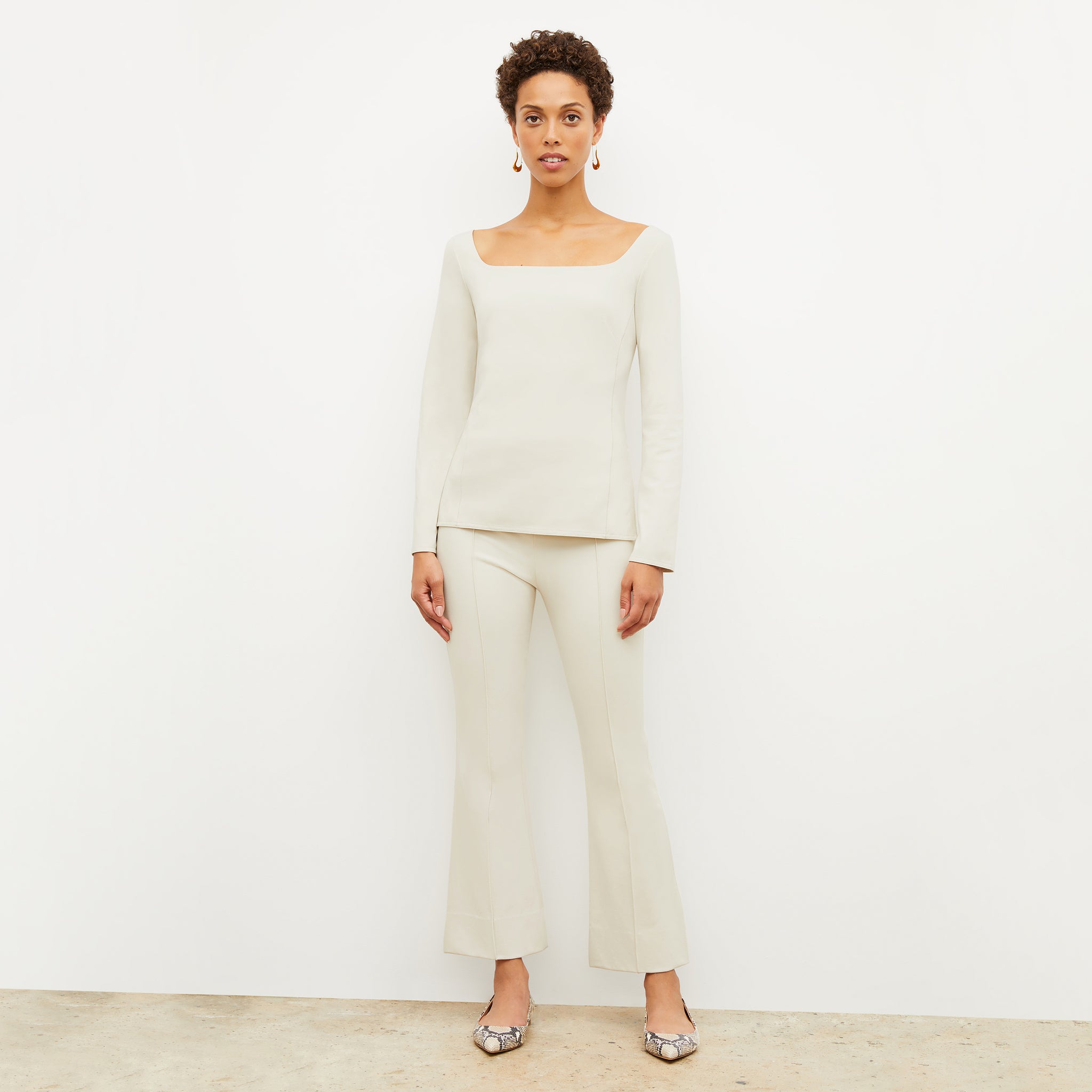 Front image of a woman standing wearing the Shiloh Pant in Pearl 