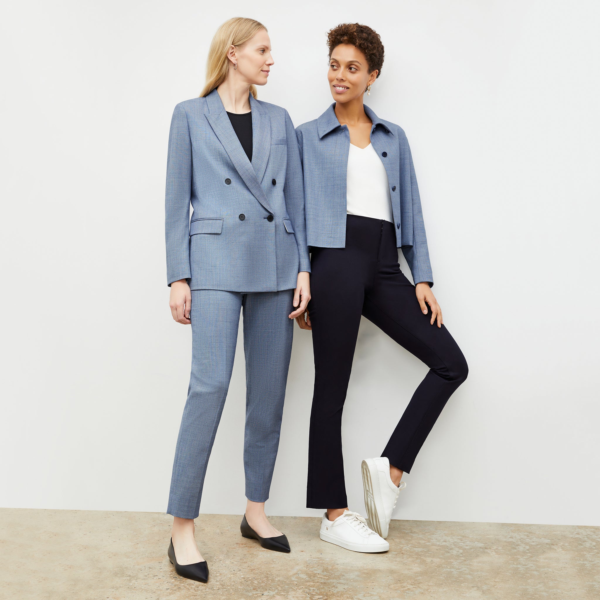 Front image of a woman wearing the ohara blazer in indigo and white and woman wearing the nicky jacket in indigo and white