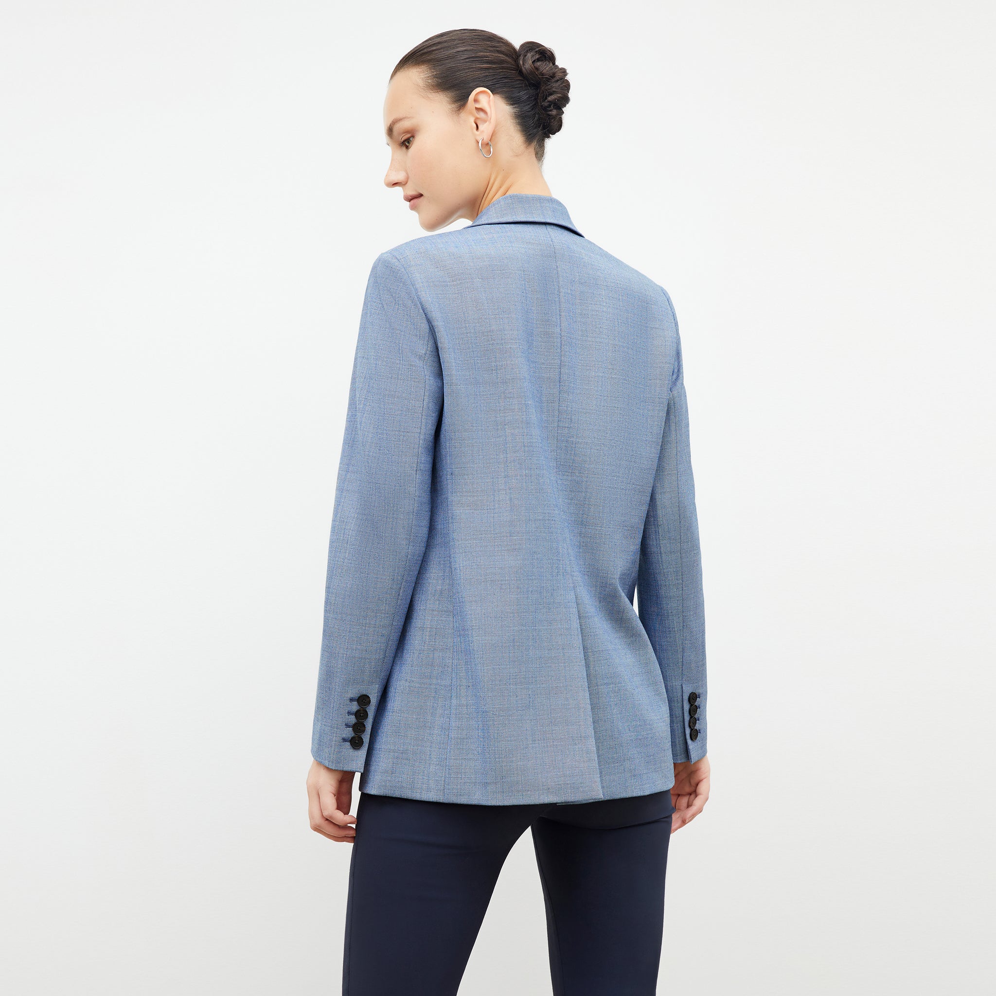Back image of a woman wearing the ohara blazer in indigo and white