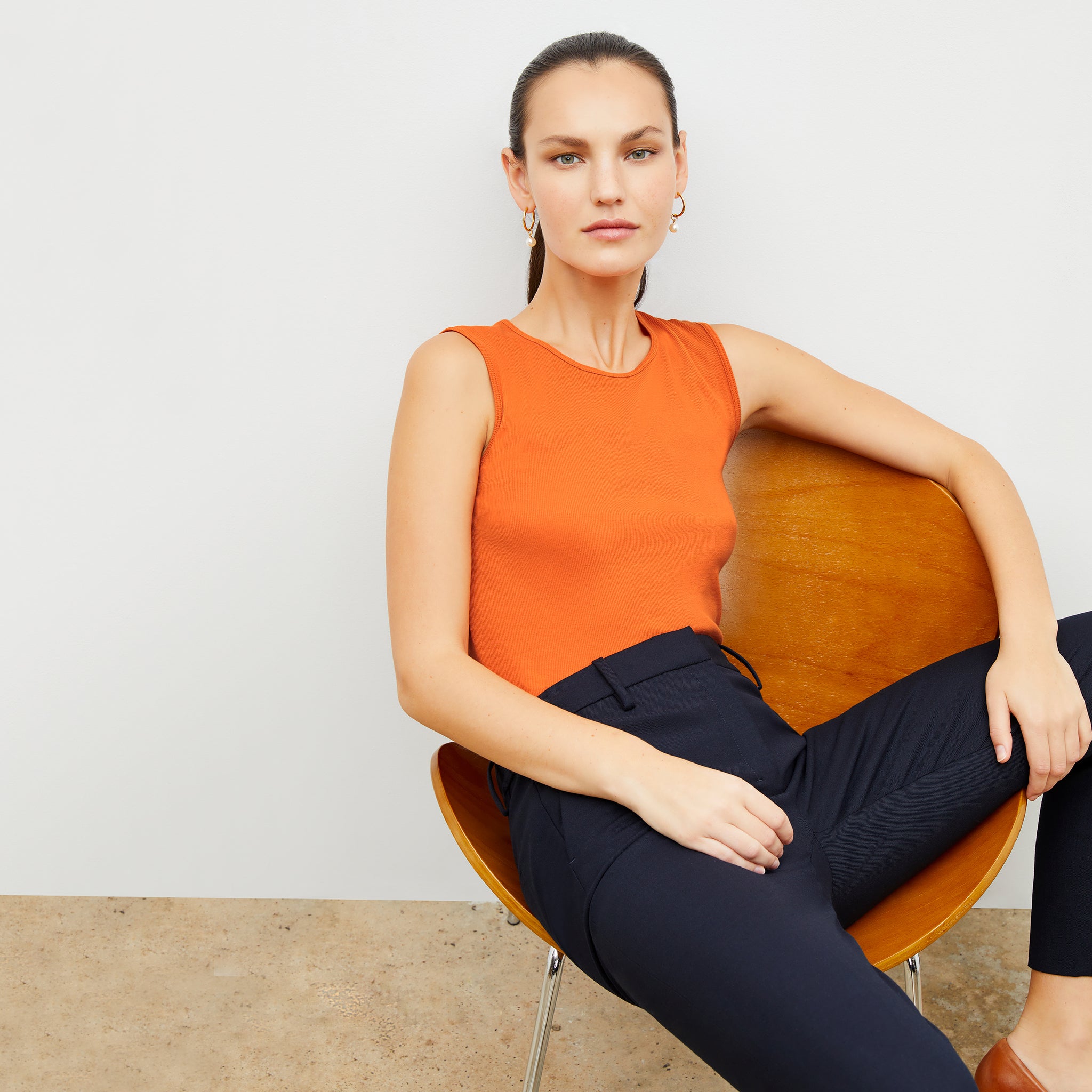 Front image of a woman wearing the paige tank in clementine 