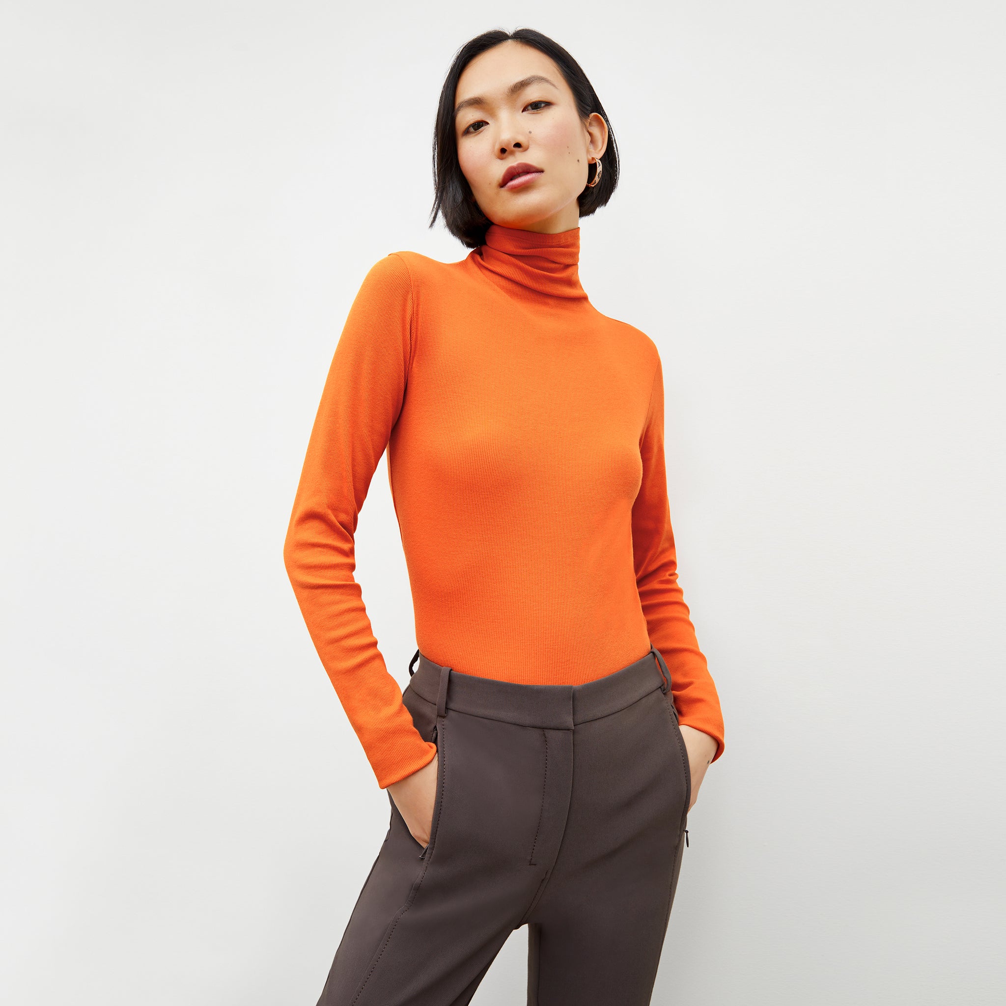 Front image of a woman wearing the axam sweater in clementine