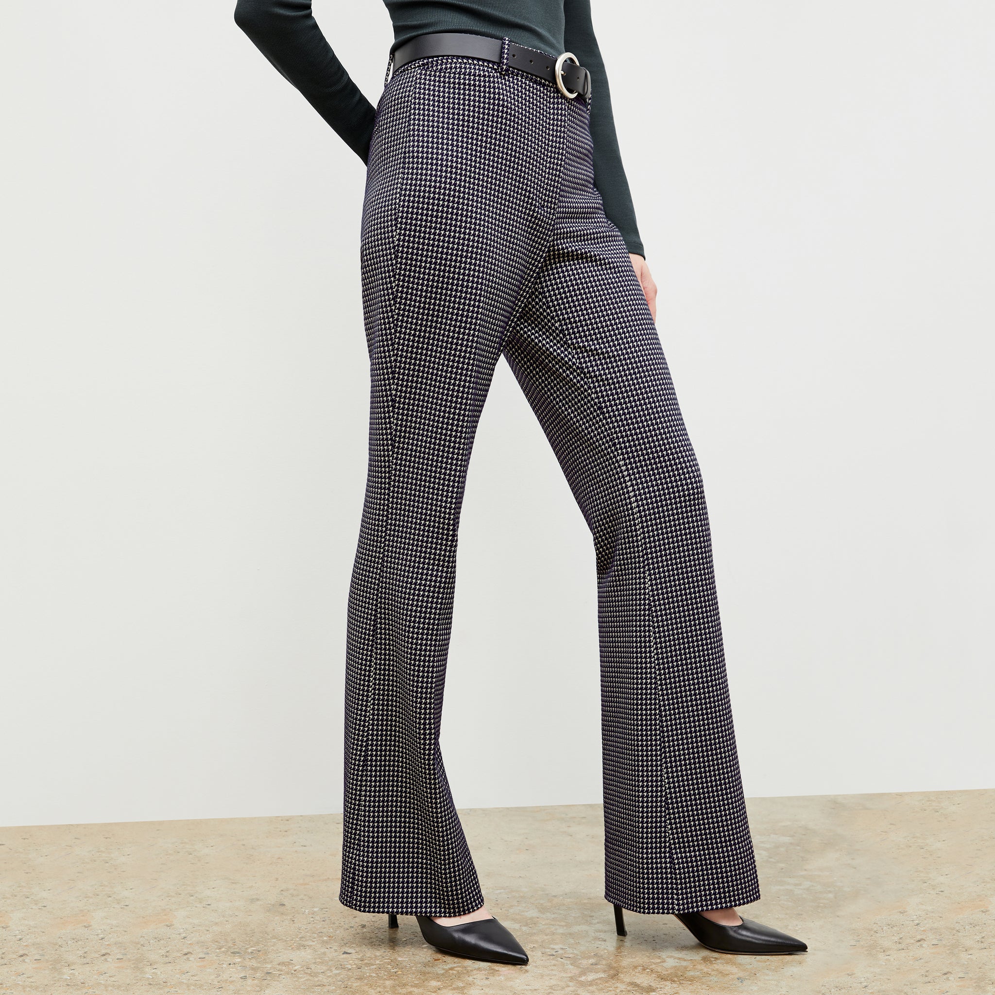 Front image of a woman wearing the horton pant in black and white houndstooth