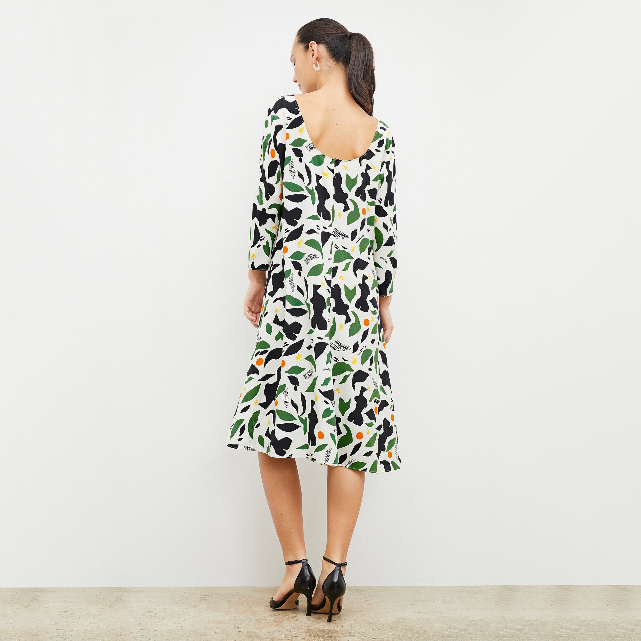Back image of woman wearing the alesia dress in icon print
