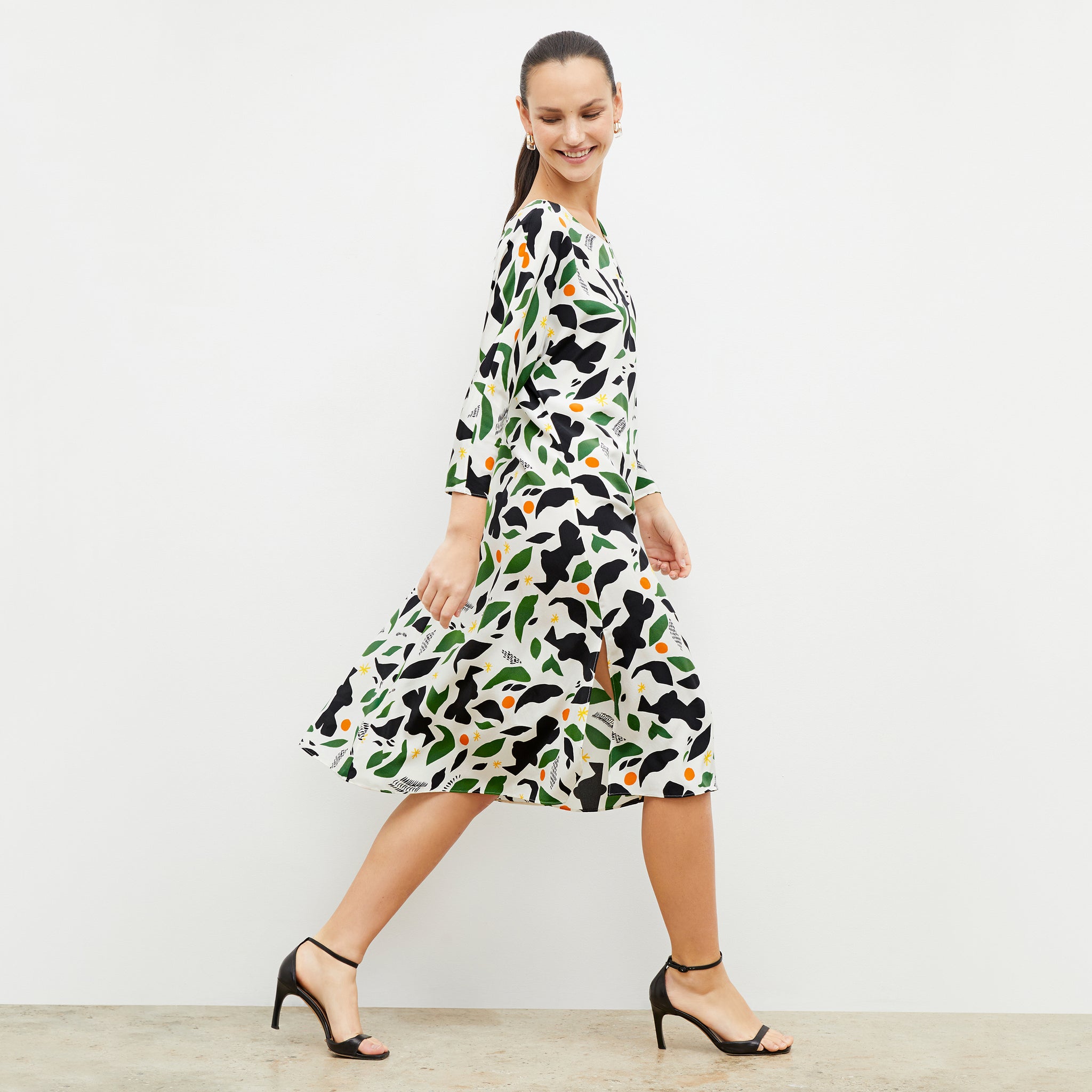 Side image of a woman wearing the alesia dress in icon print