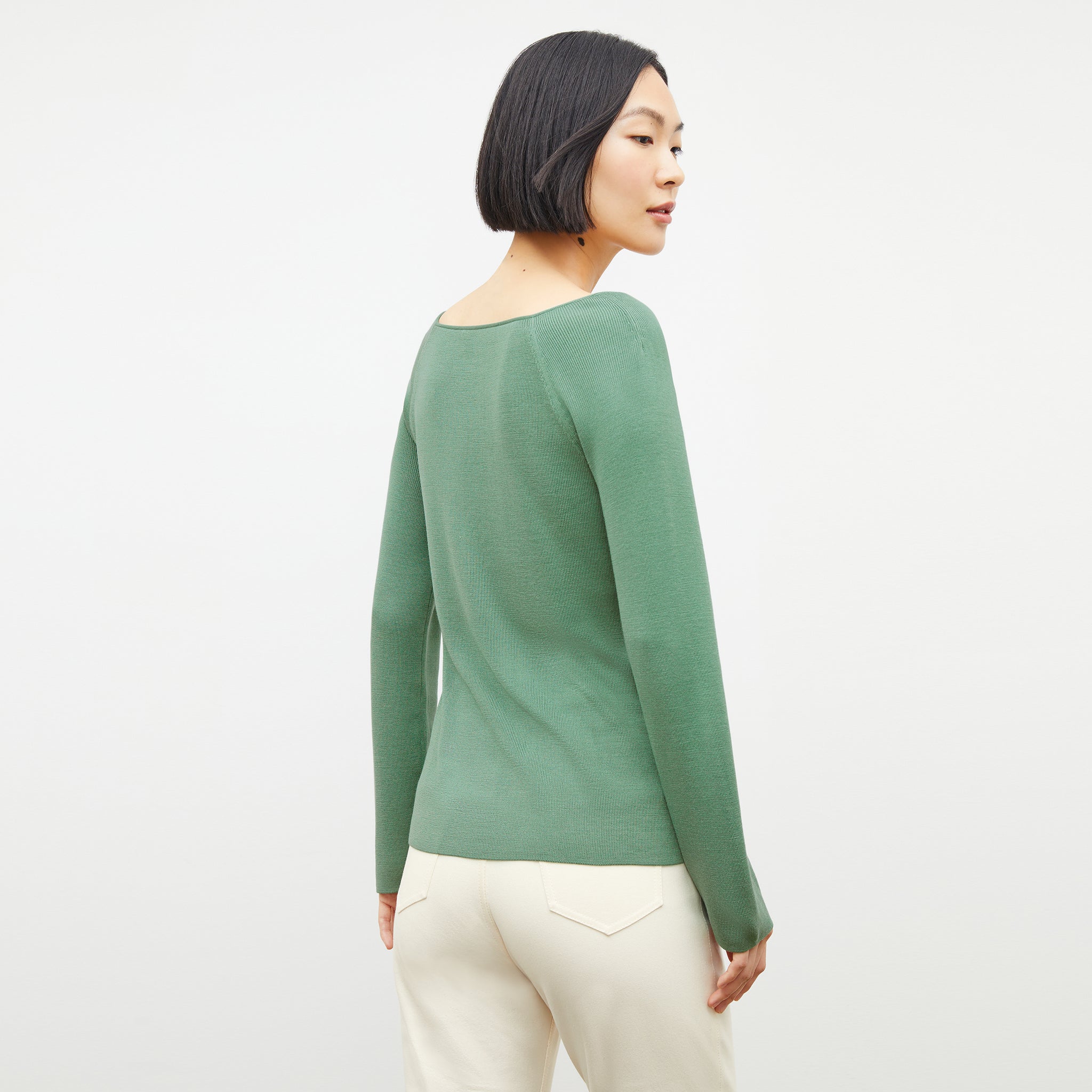 Back image of a woman wearing the joya top in spring green